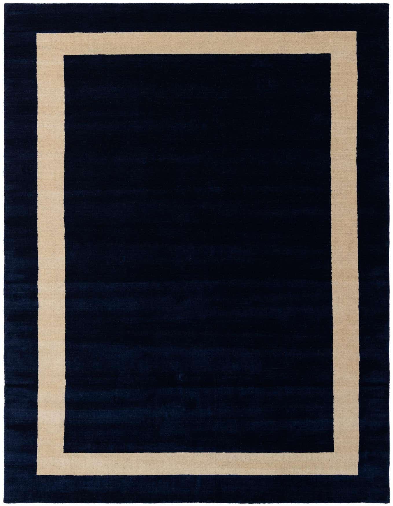 A 6x9 rectangular Jill Zarin Border Wool rug in deep cobalt blue with a wide, light beige border, suitable for a living room.