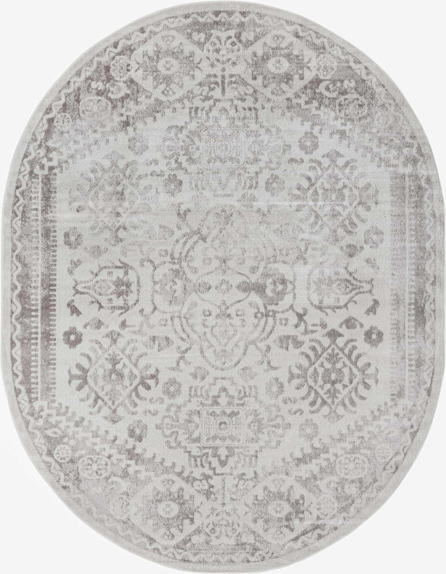 An 8' x 10' oval ivory and cream Bohemian rug with a distressed medallion and floral pattern.