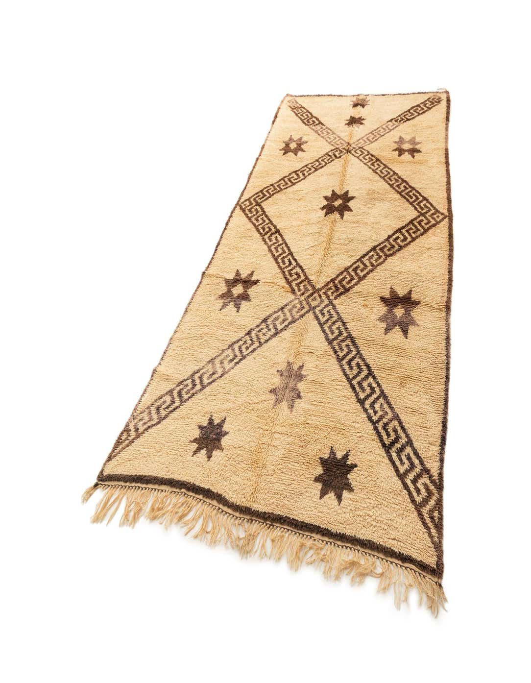 A 6x9 rectangular ivory wool rug with a dark brown geometric Greek key pattern and scattered star motifs.