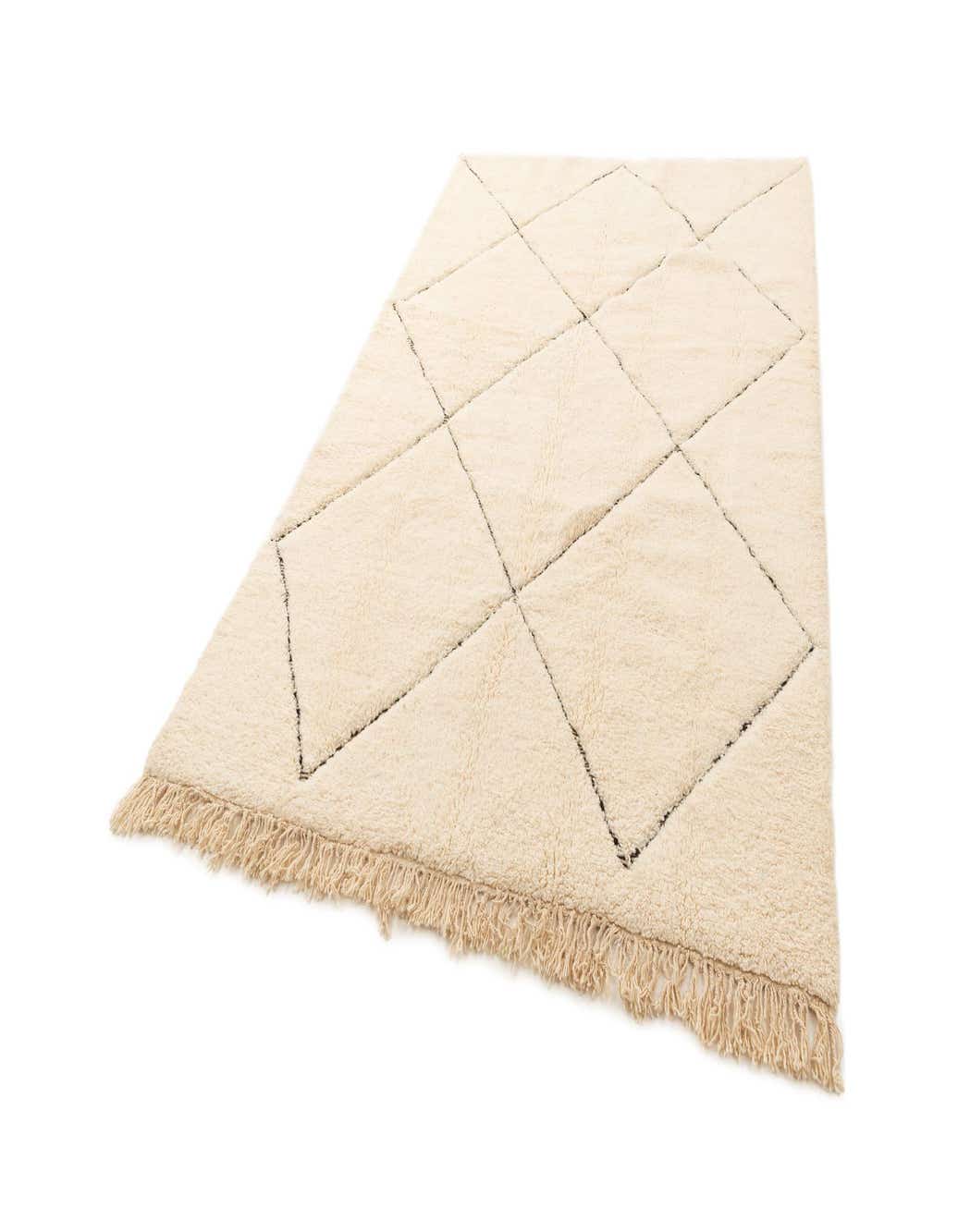 A 6x9 rectangular ivory wool rug with a black diamond pattern and fringe, ideal for a living room.