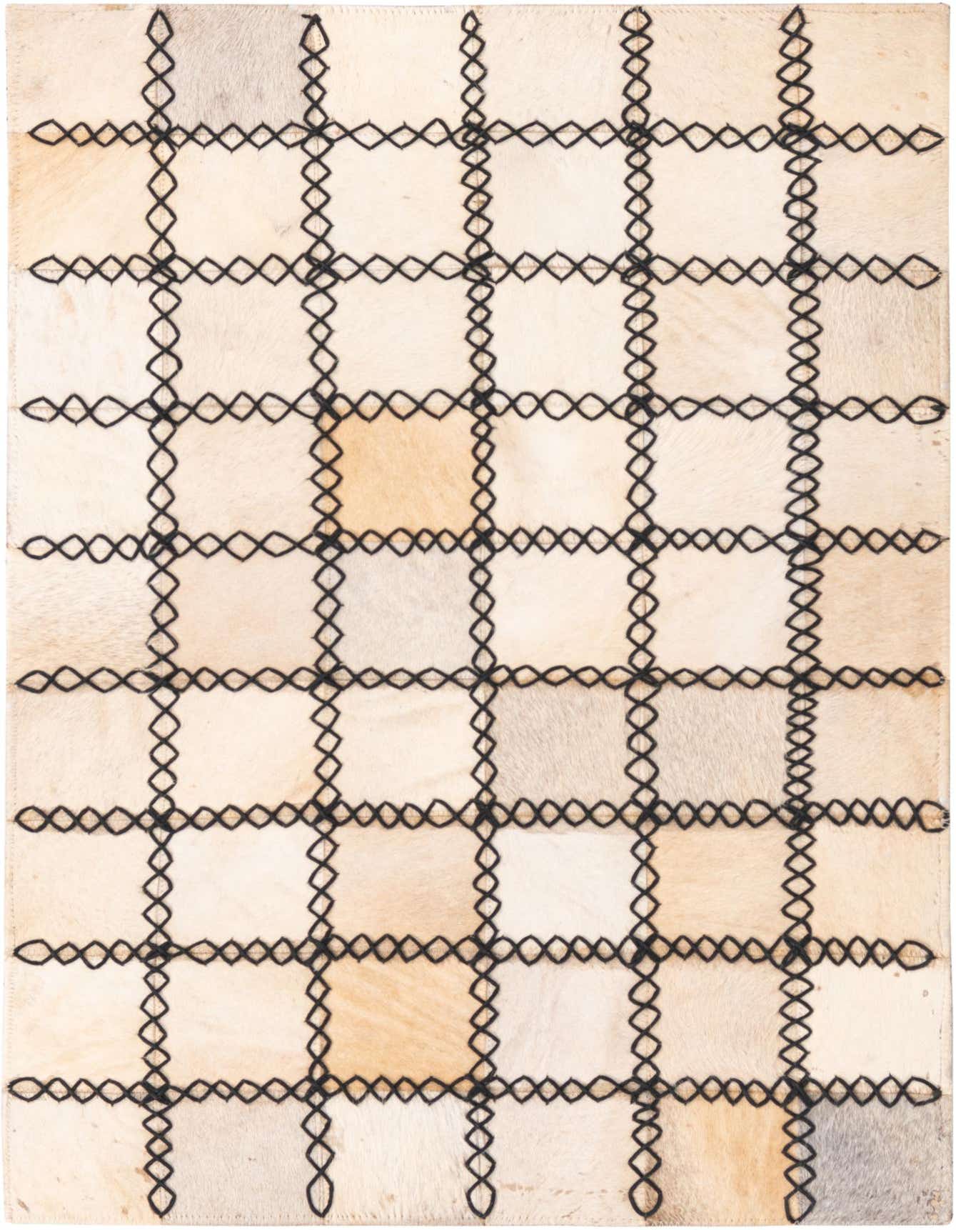 A 2x3 rectangular Cowhide rug featuring a modern grid pattern with ivory and cream patches stitched together by black leather.