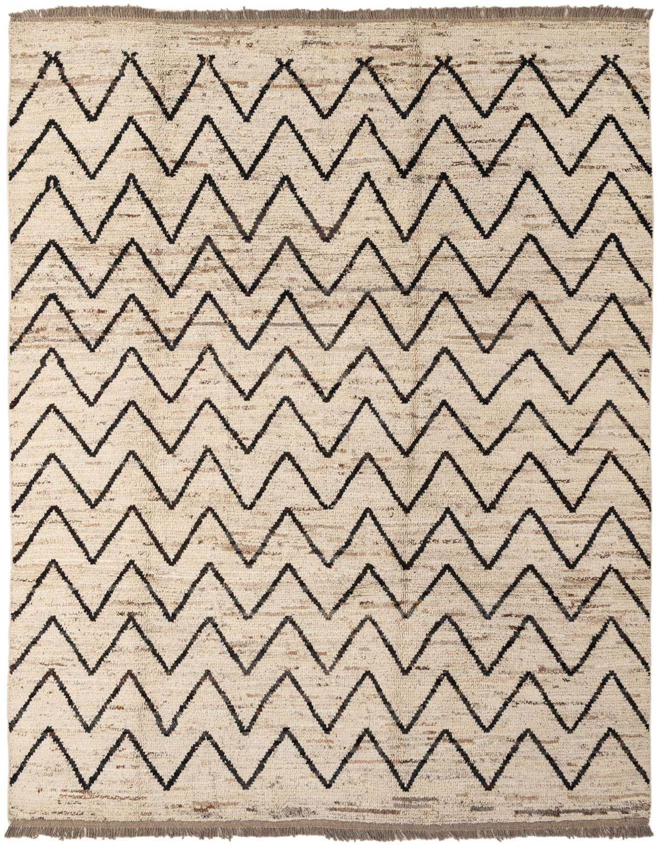 A rectangular 7x10 ivory wool rug with a modern black zigzag pattern and fringed edges, suitable for a living room.