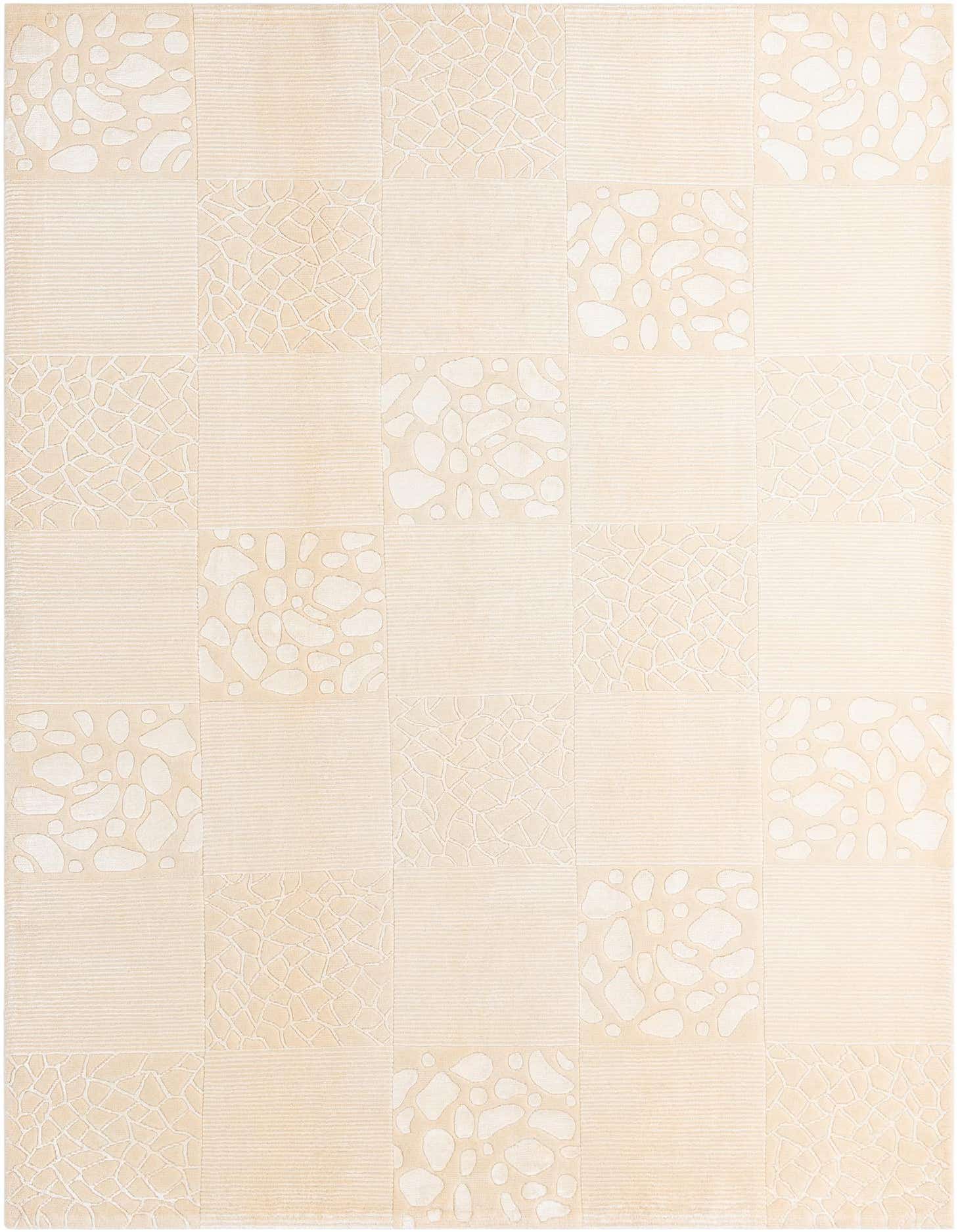 A 7x10 rectangular ivory and cream rug featuring a modern patchwork design with varying textures and abstract patterns.