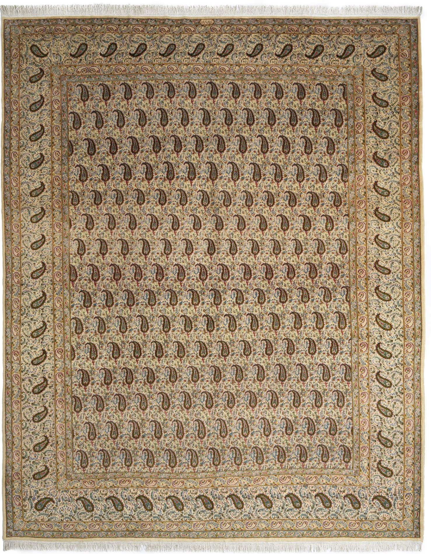 A 10x13 rectangular Kerman Persian rug in ivories and creams, featuring a dense paisley pattern and a fringed edge.