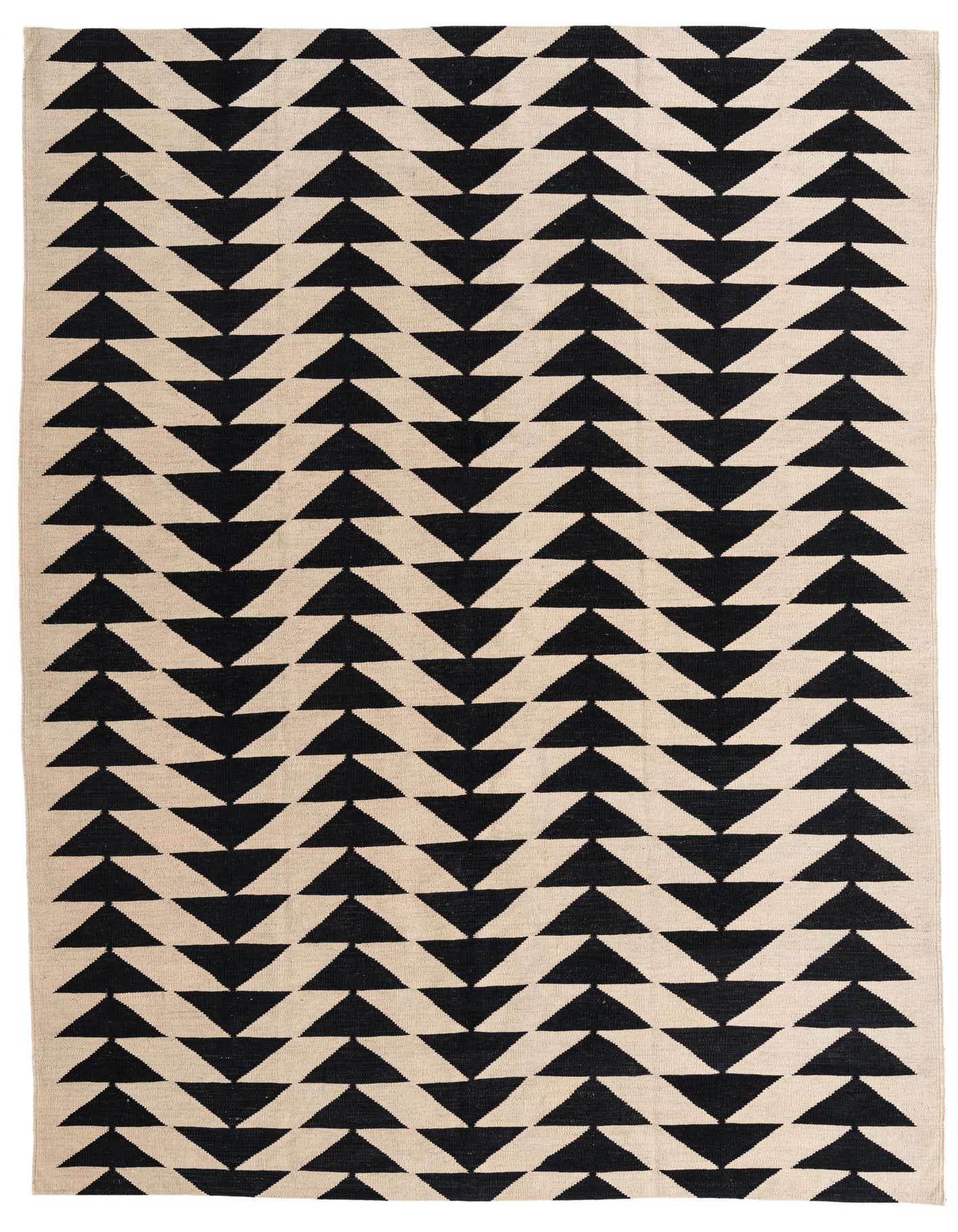 A 6x9 rectangular ivory and black flatweave wool rug with a repeating tribal geometric triangle pattern.