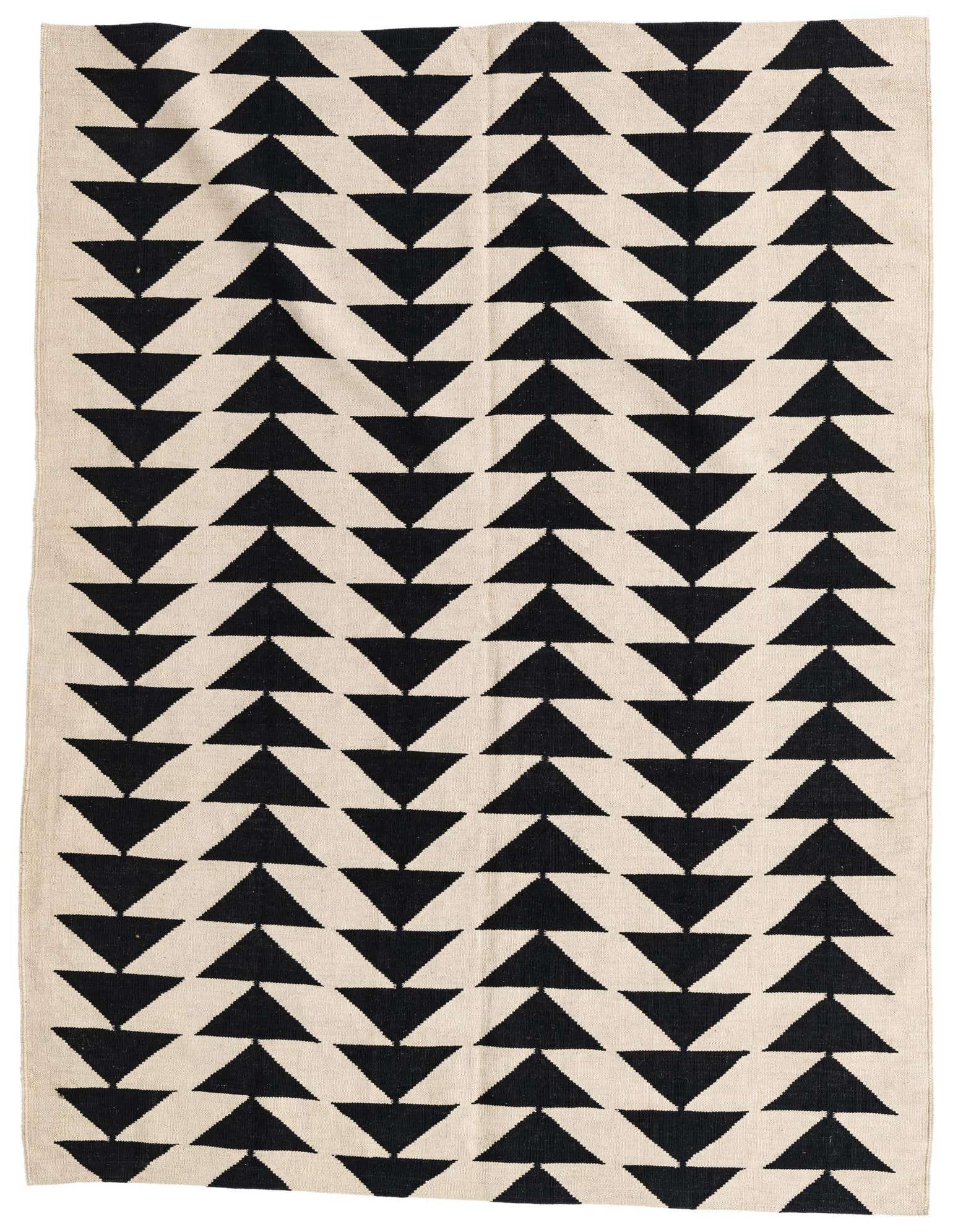 A 5x8 rectangular ivory and black flatweave wool rug with a repeating tribal triangle pattern, ideal for a modern living room.