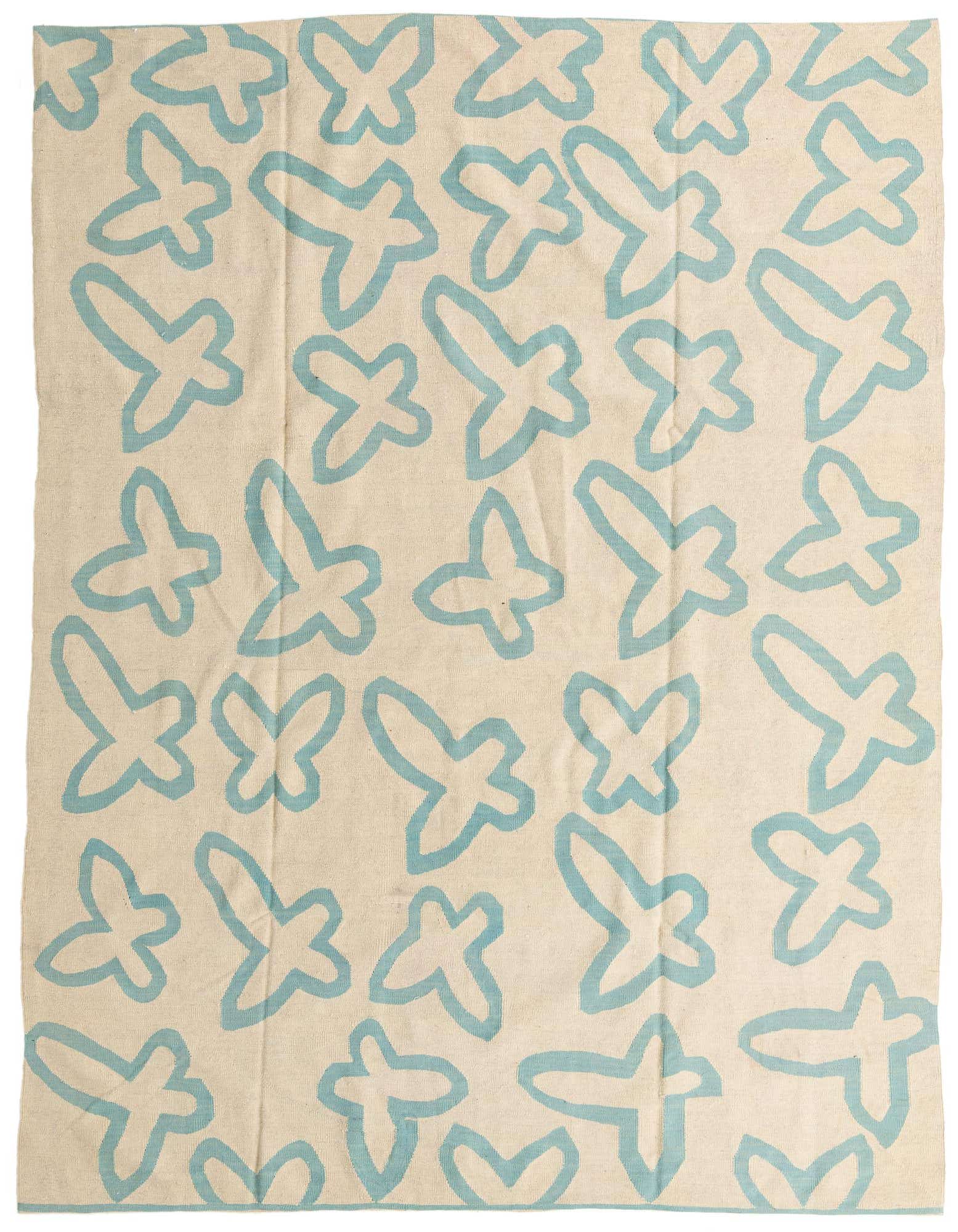 An 8x10 rectangular ivory flatweave rug with a scattered, light blue abstract butterfly or tribal pattern.