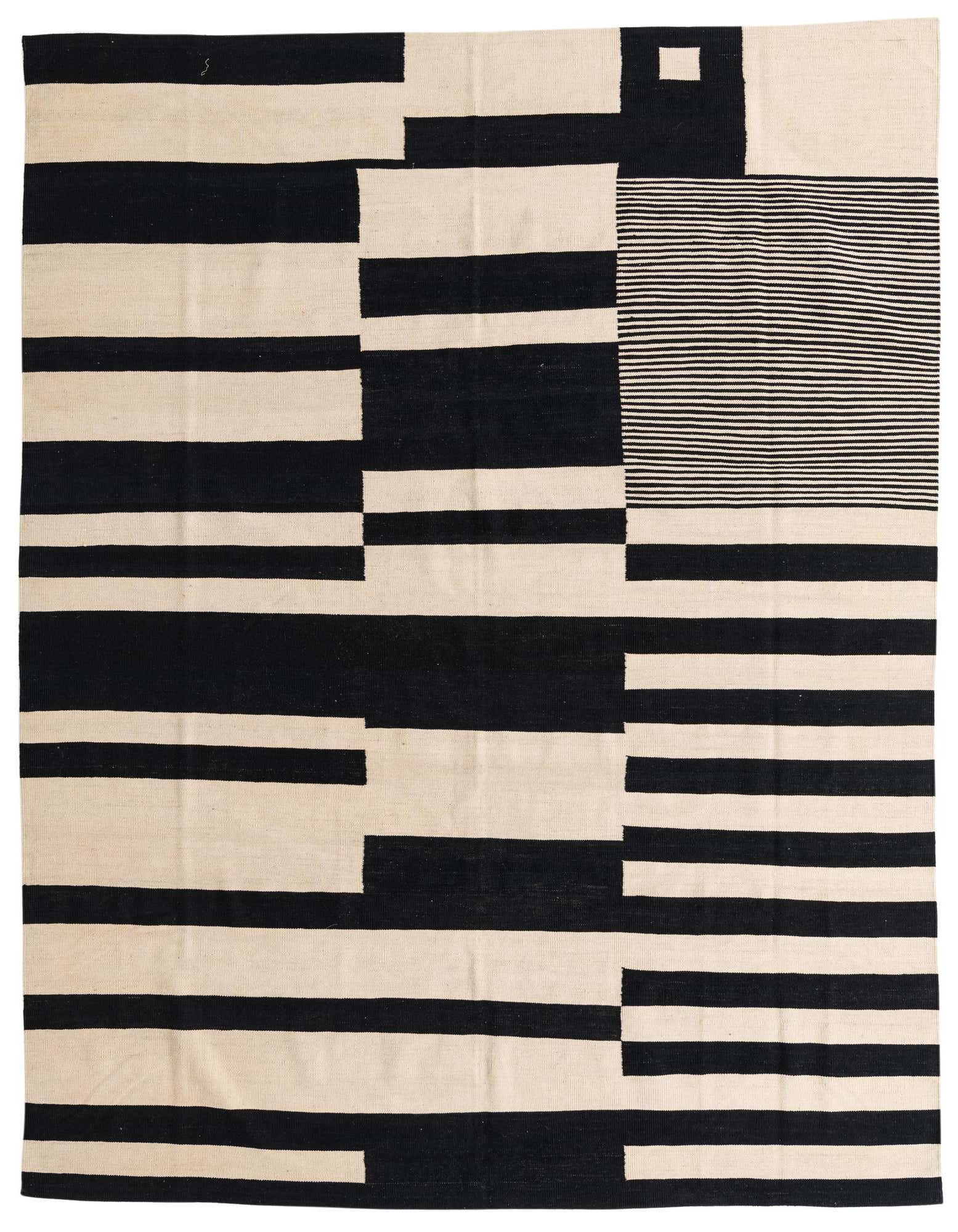 An 8x10 rectangular flatweave wool rug featuring a bold abstract tribal pattern in black and ivory, suitable for a modern living room.