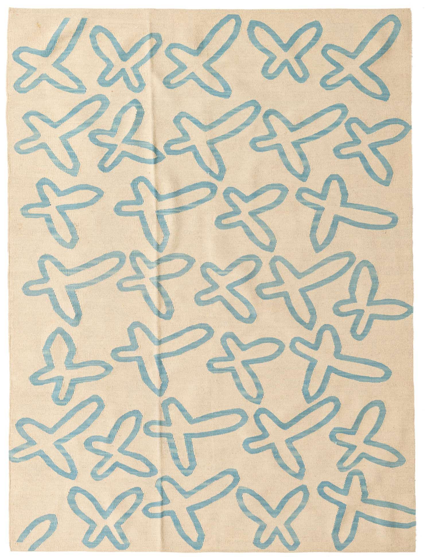 A 6x9 rectangular ivory flatweave wool rug with an abstract, light blue tribal pattern scattered across its surface.