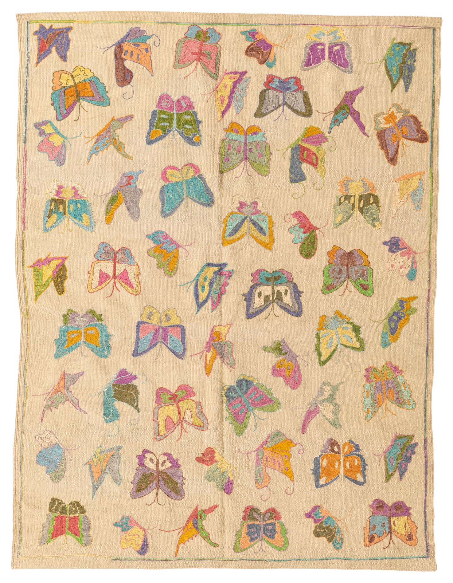 A 4x6 rectangular ivory flatweave rug featuring a vibrant, multicolored butterfly pattern, perfect for a living room.