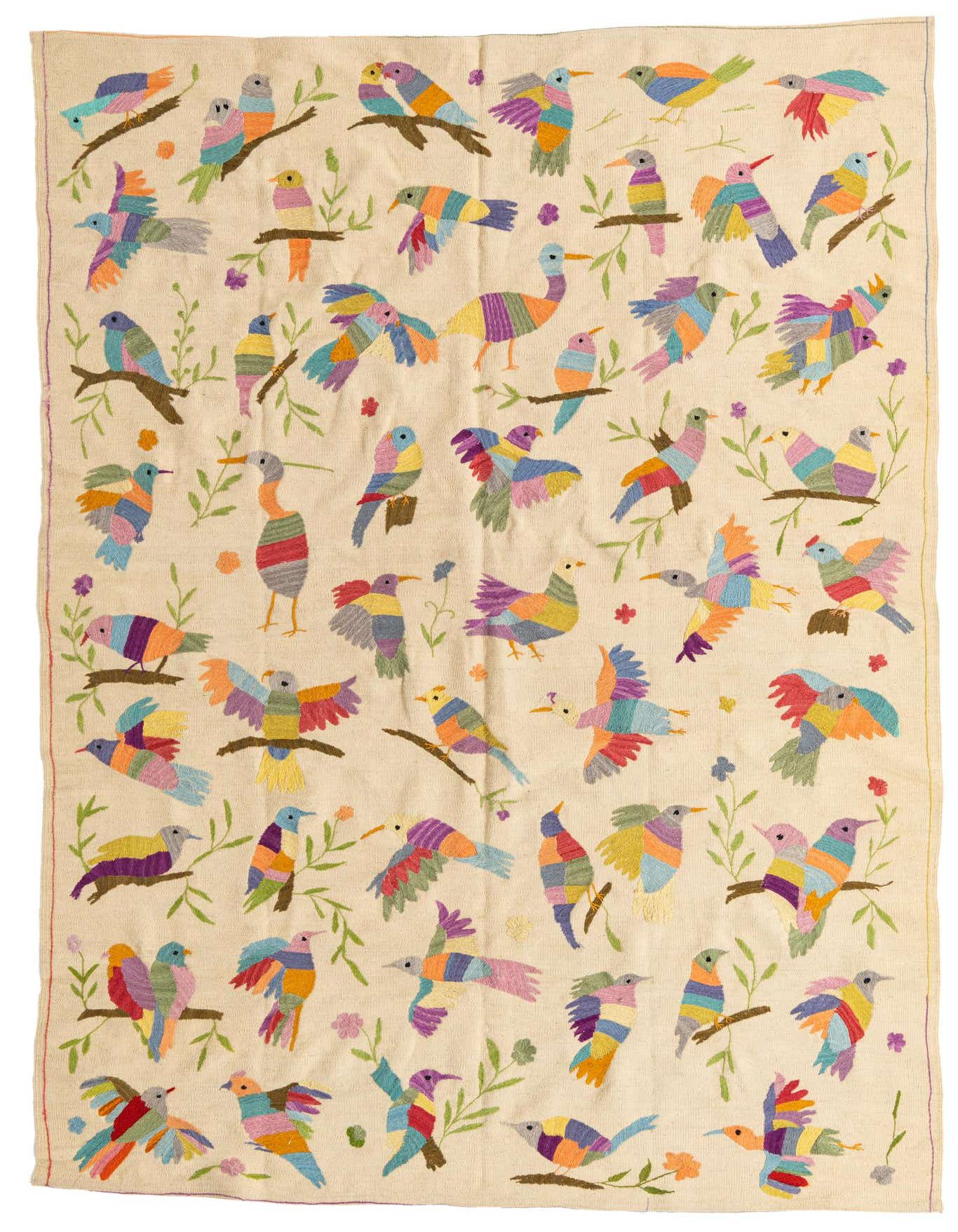 A 6x9 rectangular ivory Kilim Suzani rug featuring a vibrant, colorful tribal bird pattern with green branches and small flowers.
