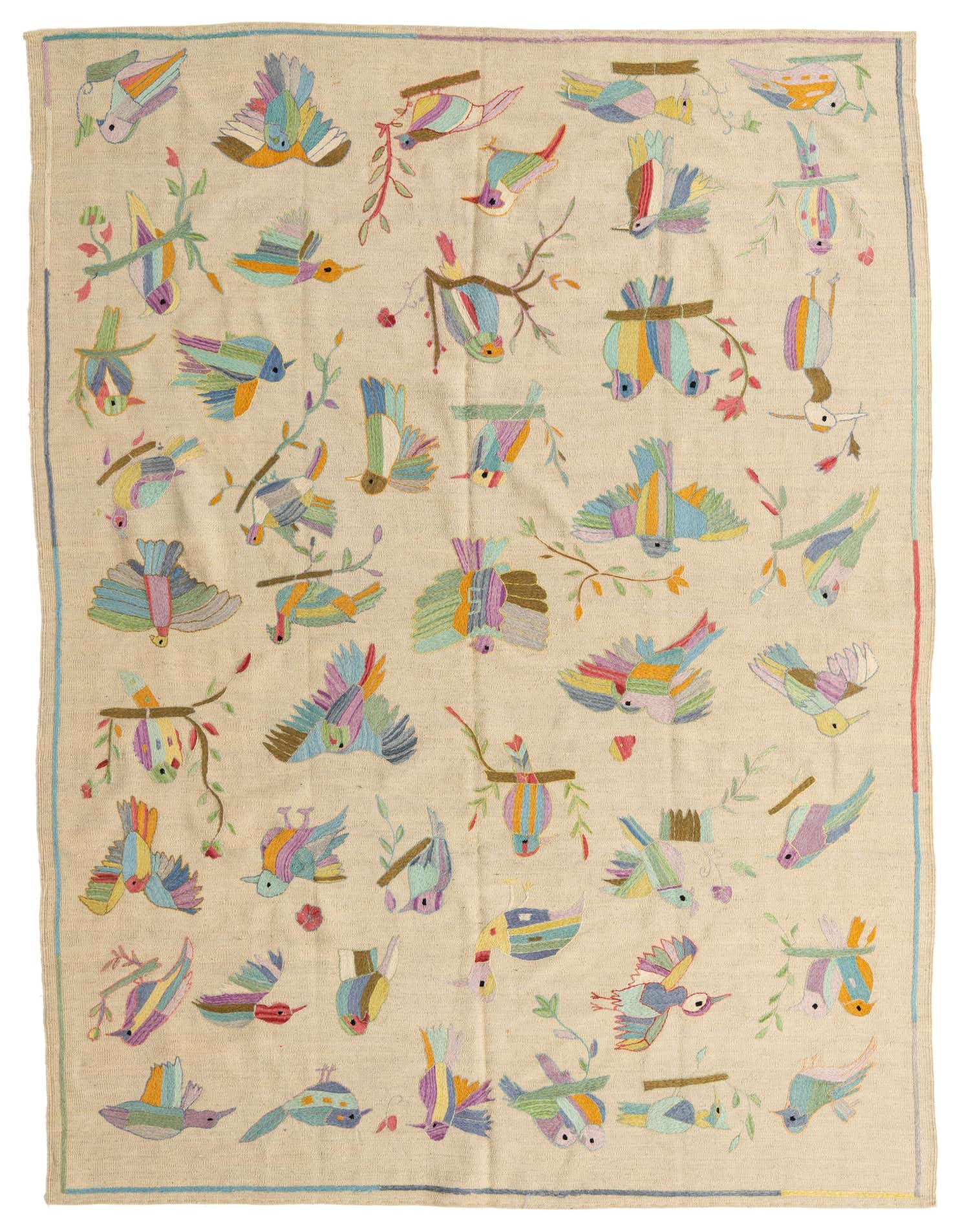 A 6x9 rectangular ivory flatweave rug with a colorful, whimsical pattern of various birds and branches.