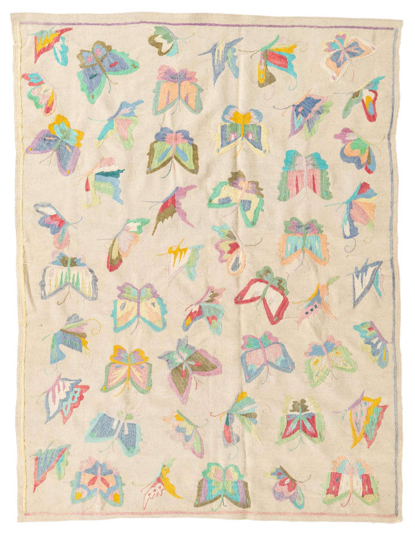A 4x6 ivory rectangular flatweave rug featuring a vibrant, scattered butterfly motif in various pastel colors, perfect for a modern living space.