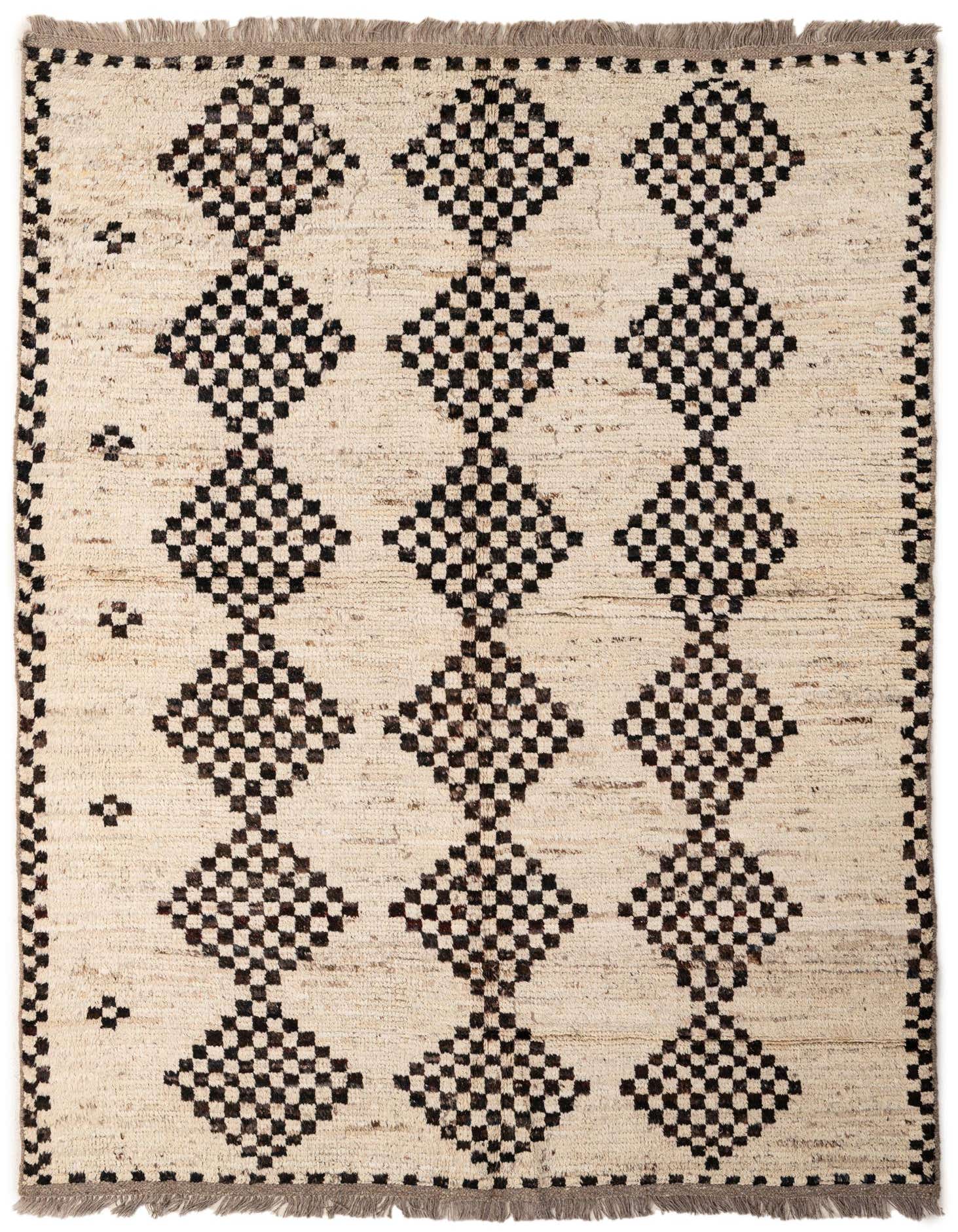 A 5x8 rectangular ivory wool rug with a tribal pattern of large black checkered diamonds and fringe.