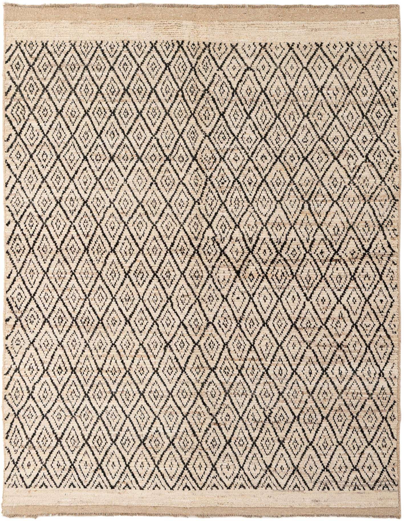 A 5x8 rectangular ivory wool rug with a black tribal diamond pattern, featuring a medium pile and handmade texture.