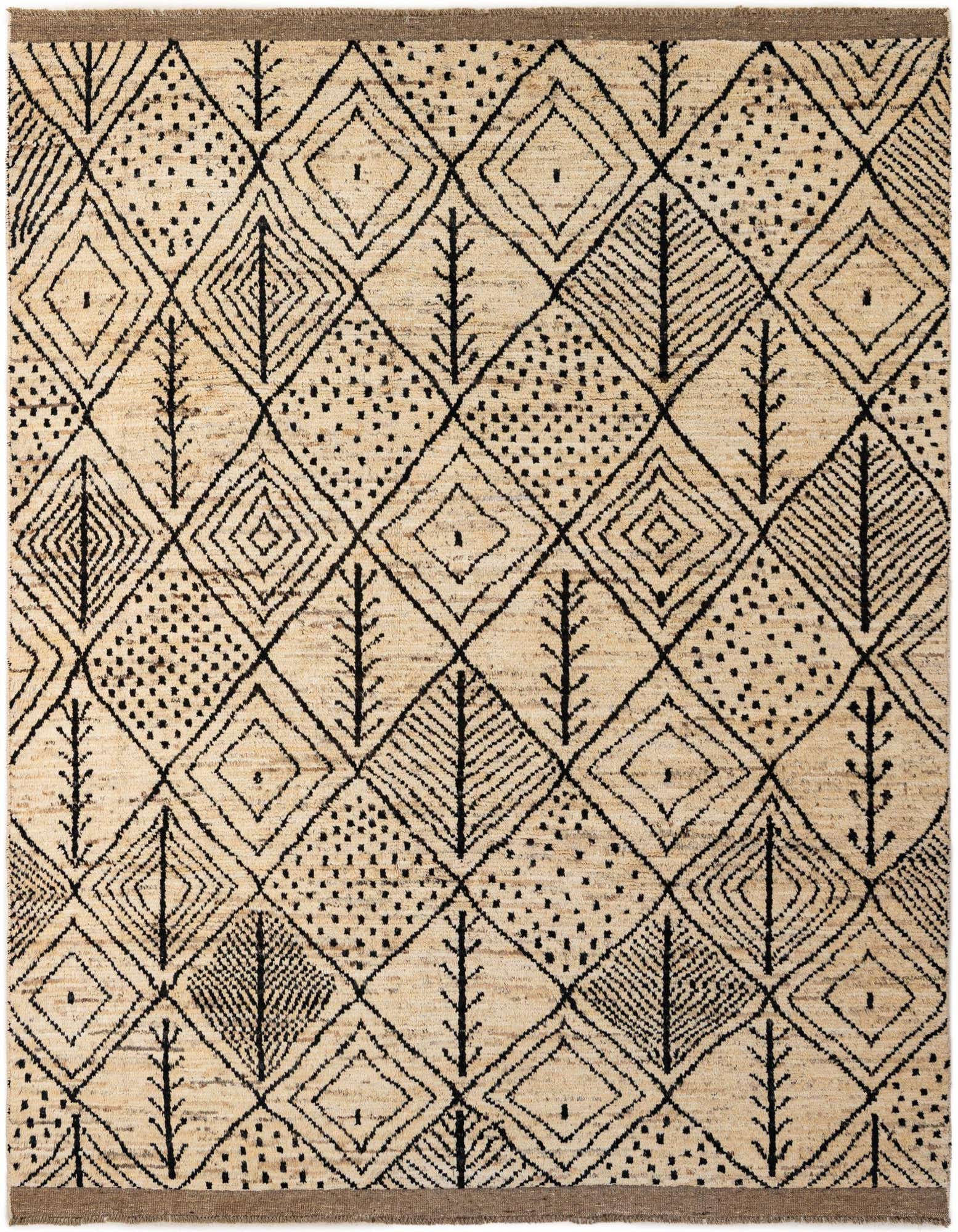 An 8x10 rectangular ivory shag rug with a bold black tribal geometric pattern, featuring diamonds and dotted sections.