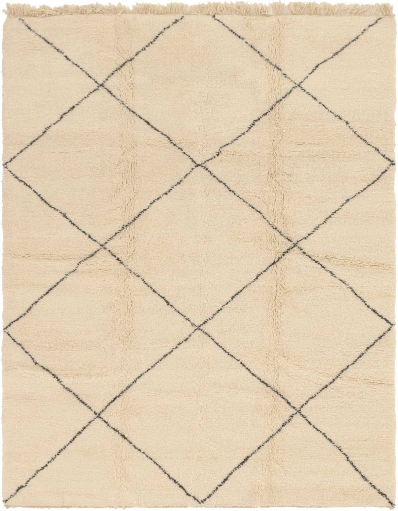 A 7x10 rectangular ivory shag rug with a black tribal diamond pattern and fringed edges.