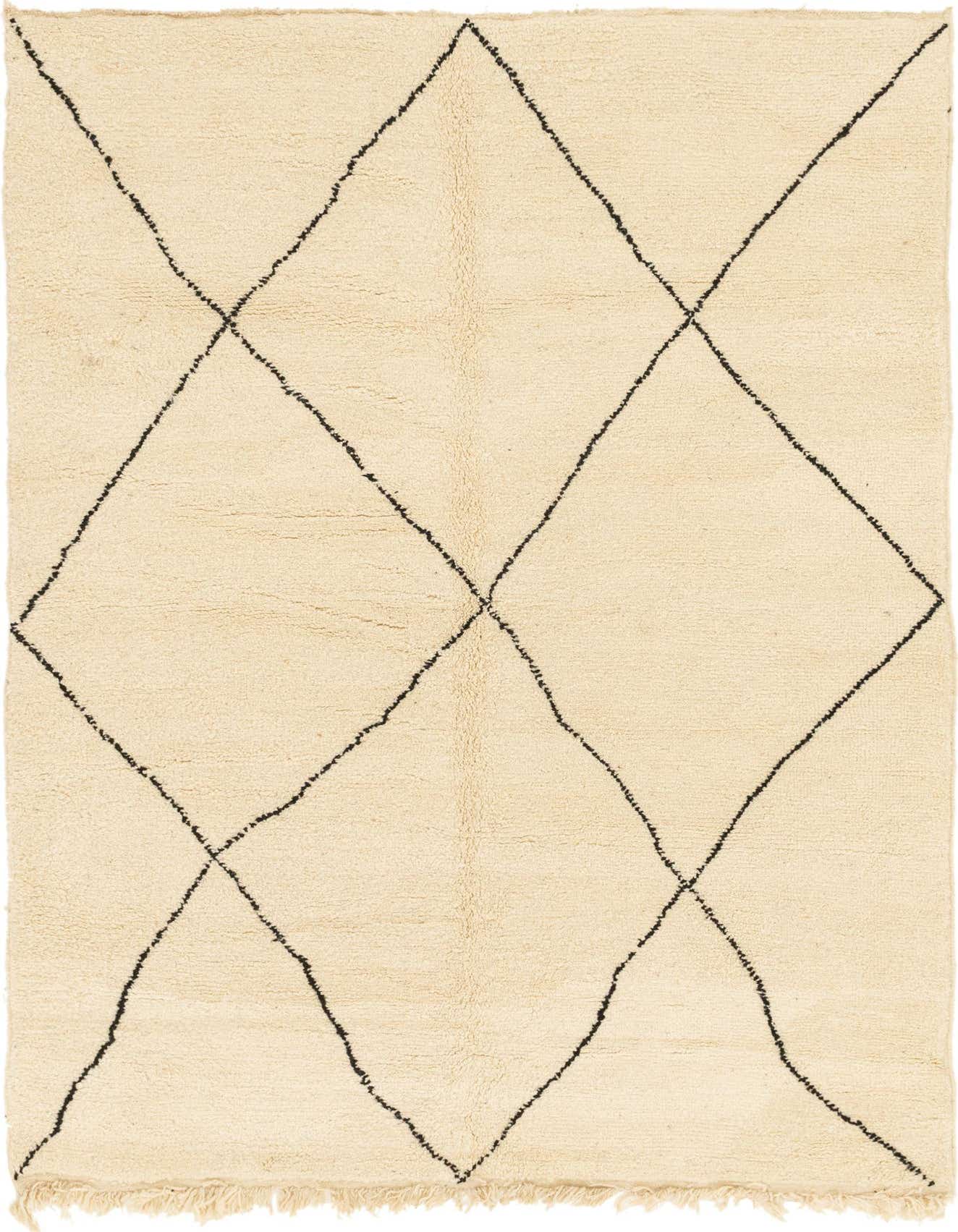 A 6x9 rectangular ivory shag rug with a black tribal diamond pattern, ideal for a living room or bedroom.