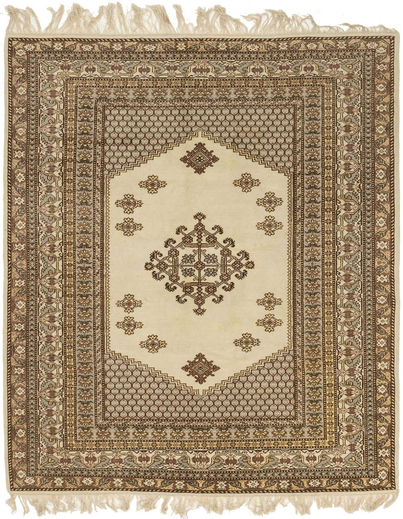 A 6x9 rectangular ivory wool rug with a central medallion and tribal patterns in brown and cream, featuring fringed edges.