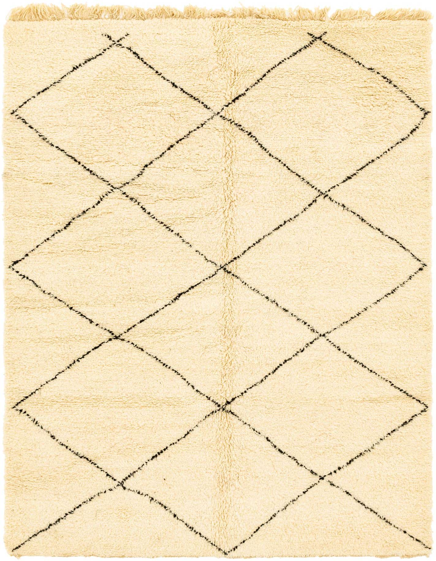 A 6x9 rectangular ivory shag rug with a black tribal diamond pattern and fringed edges, suitable for a living room.