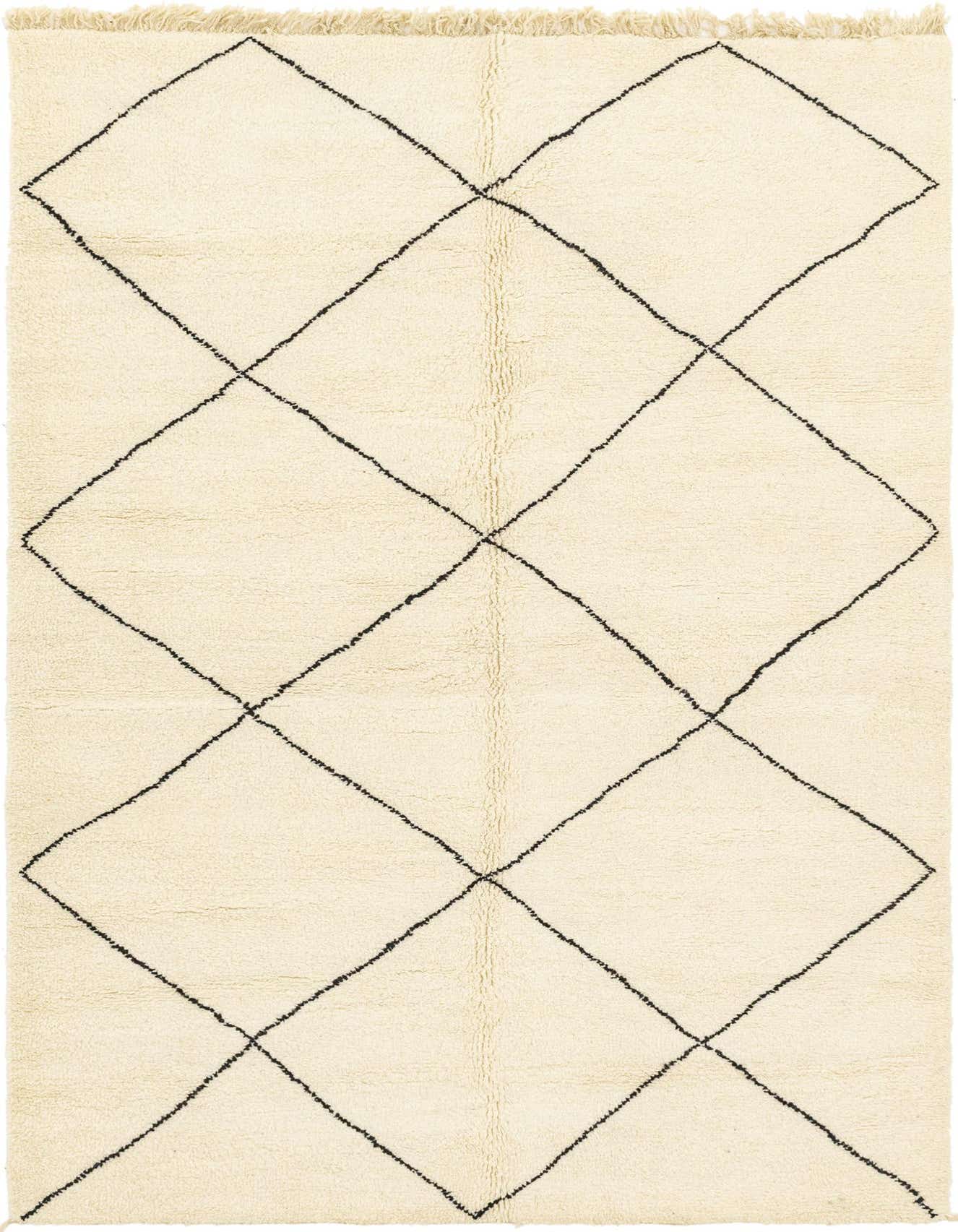 A 6x9 rectangular ivory shag rug with a bold black tribal diamond pattern, perfect for a modern living room.