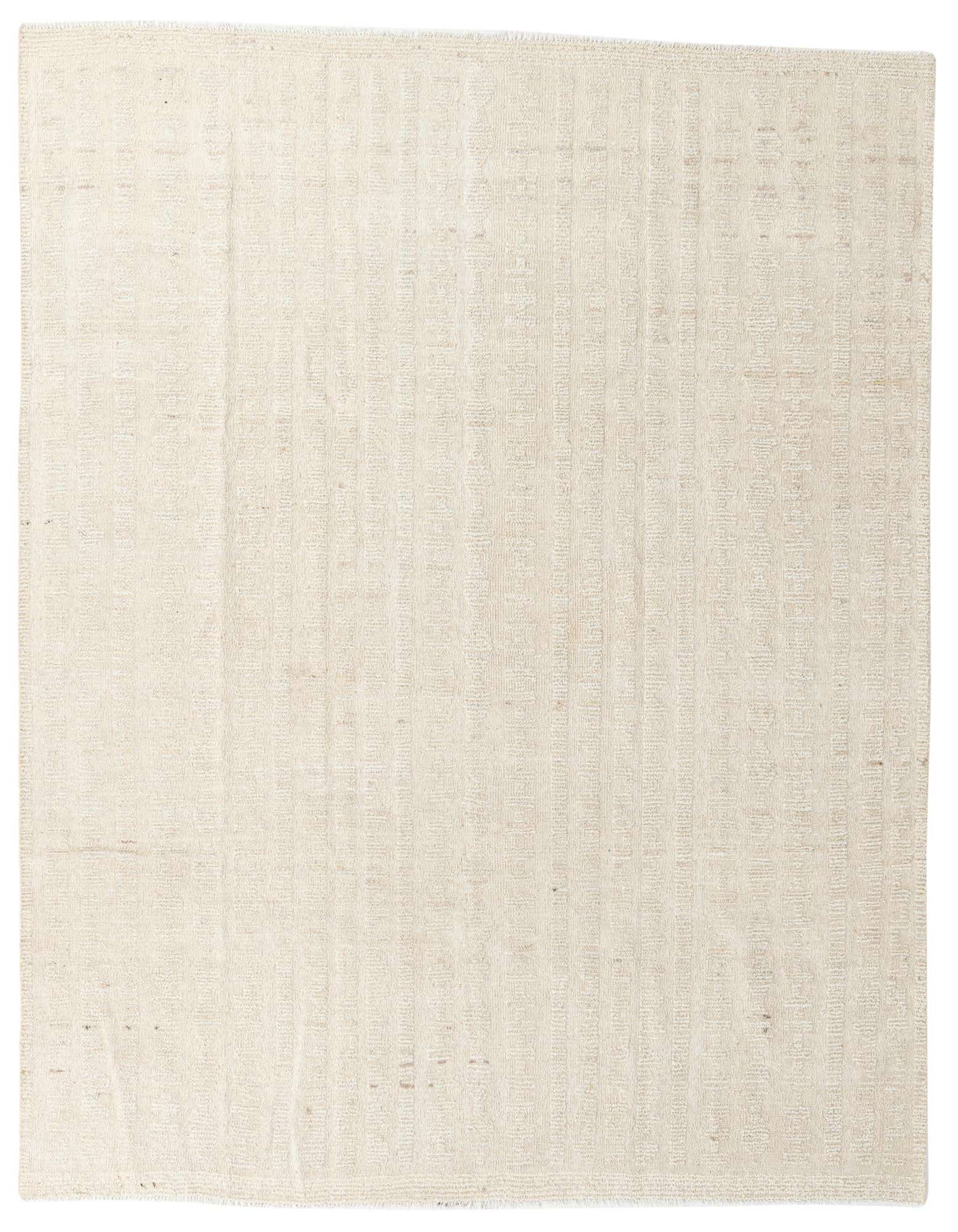 An 8x10 rectangular ivory shag rug with a subtle tribal pattern, perfect for a modern living room.