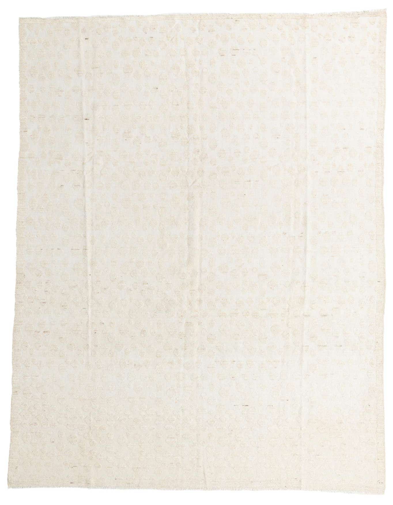 A 10x14 rectangular ivory wool shag rug with a subtle tribal pattern, ideal for a modern living room.