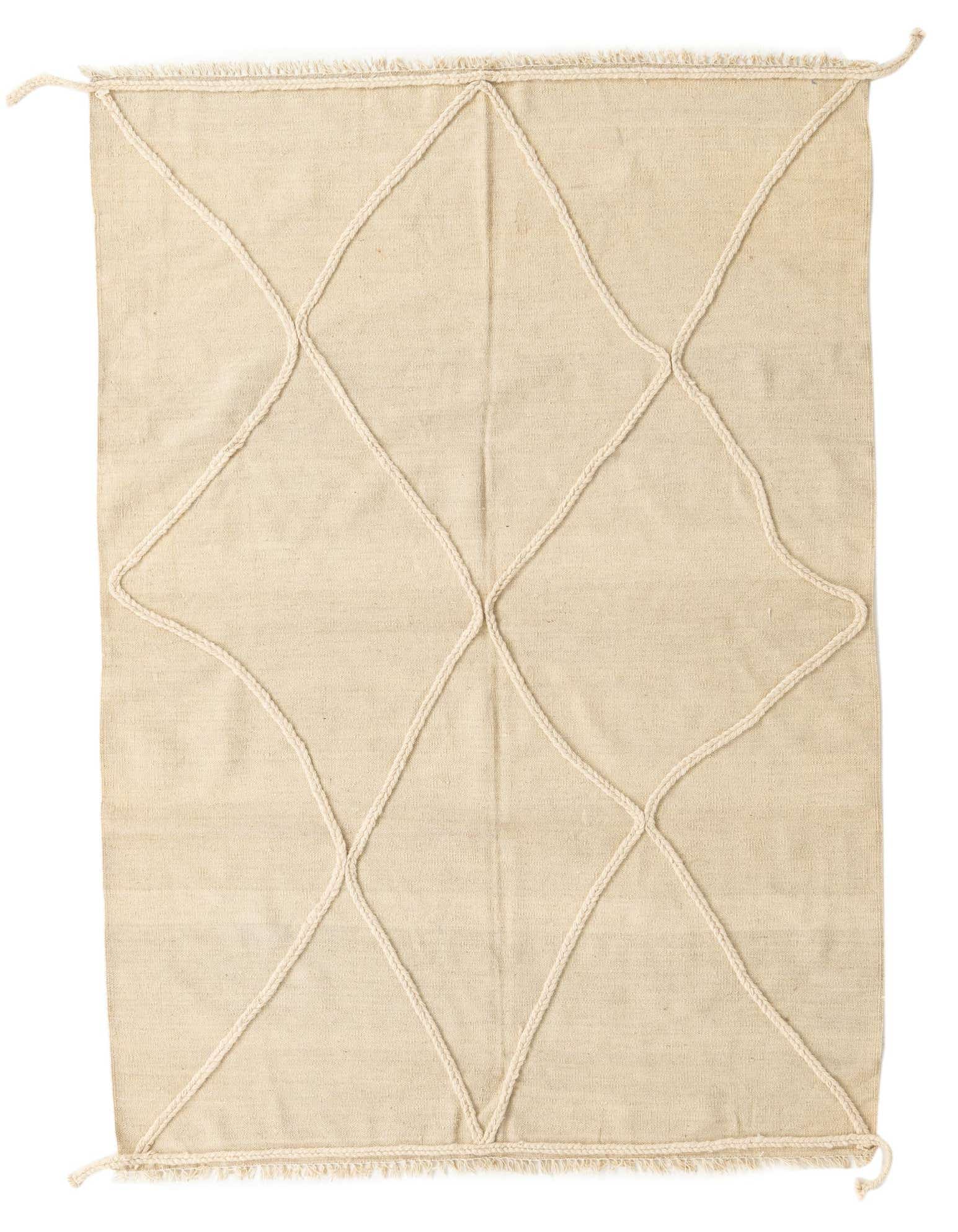 A 4x6 rectangular ivory wool shag rug with a raised braided diamond pattern, handmade for a tribal modern look.
