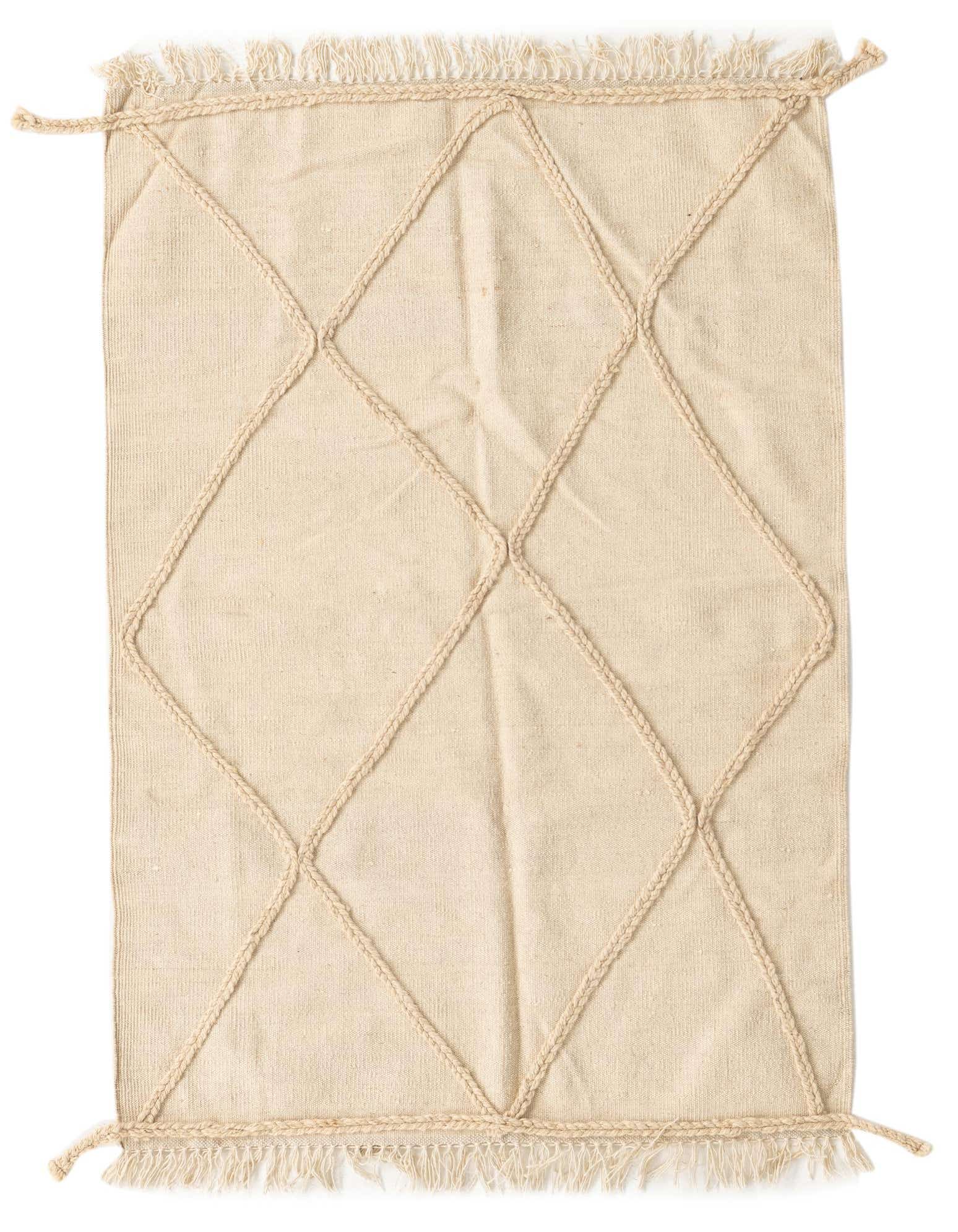 A 3x5 rectangular ivory wool shag rug with a braided tribal diamond pattern and fringe.