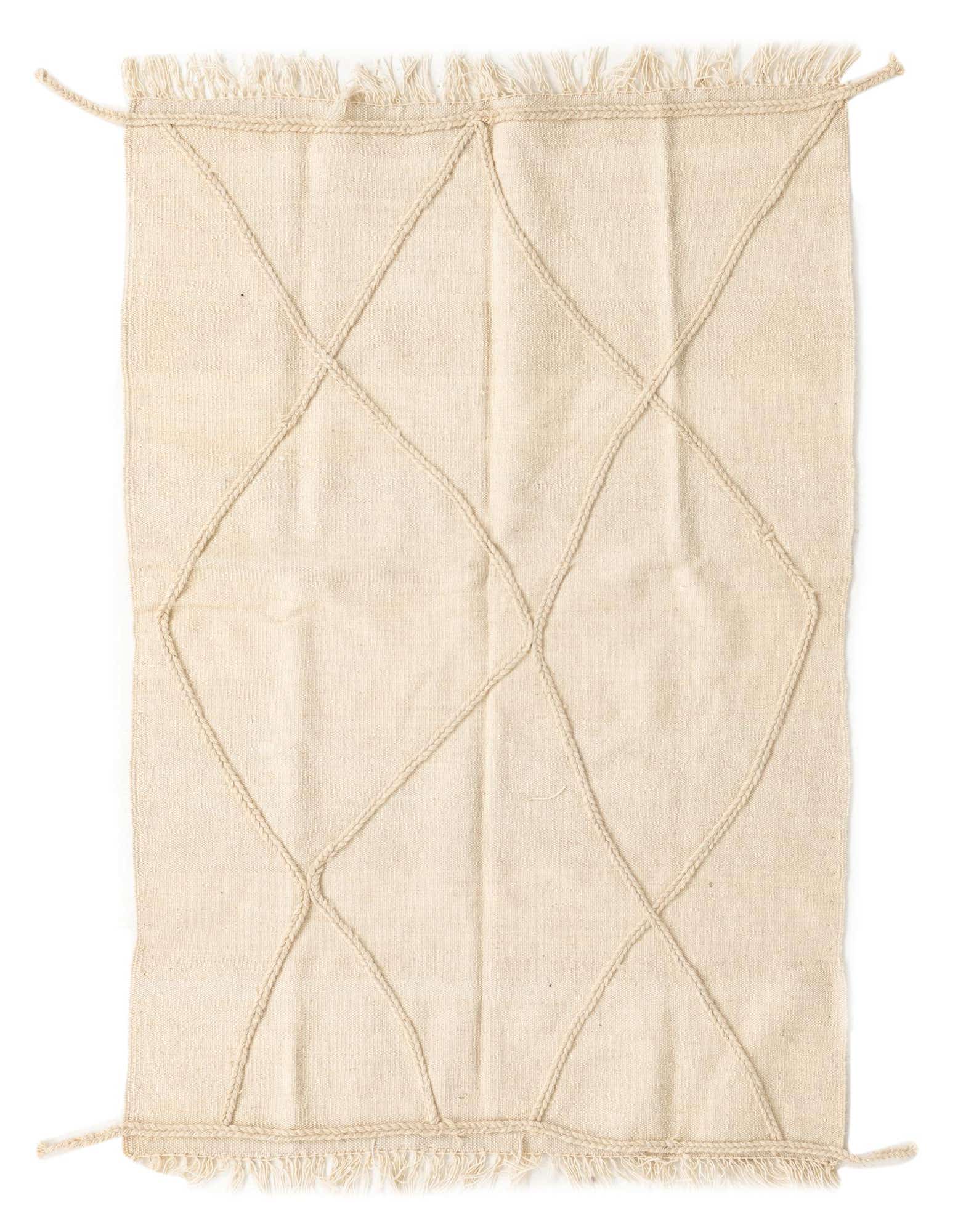 A 3x5 rectangular ivory wool shag rug with a modern tribal diamond pattern formed by raised braided lines, featuring fringed edges.