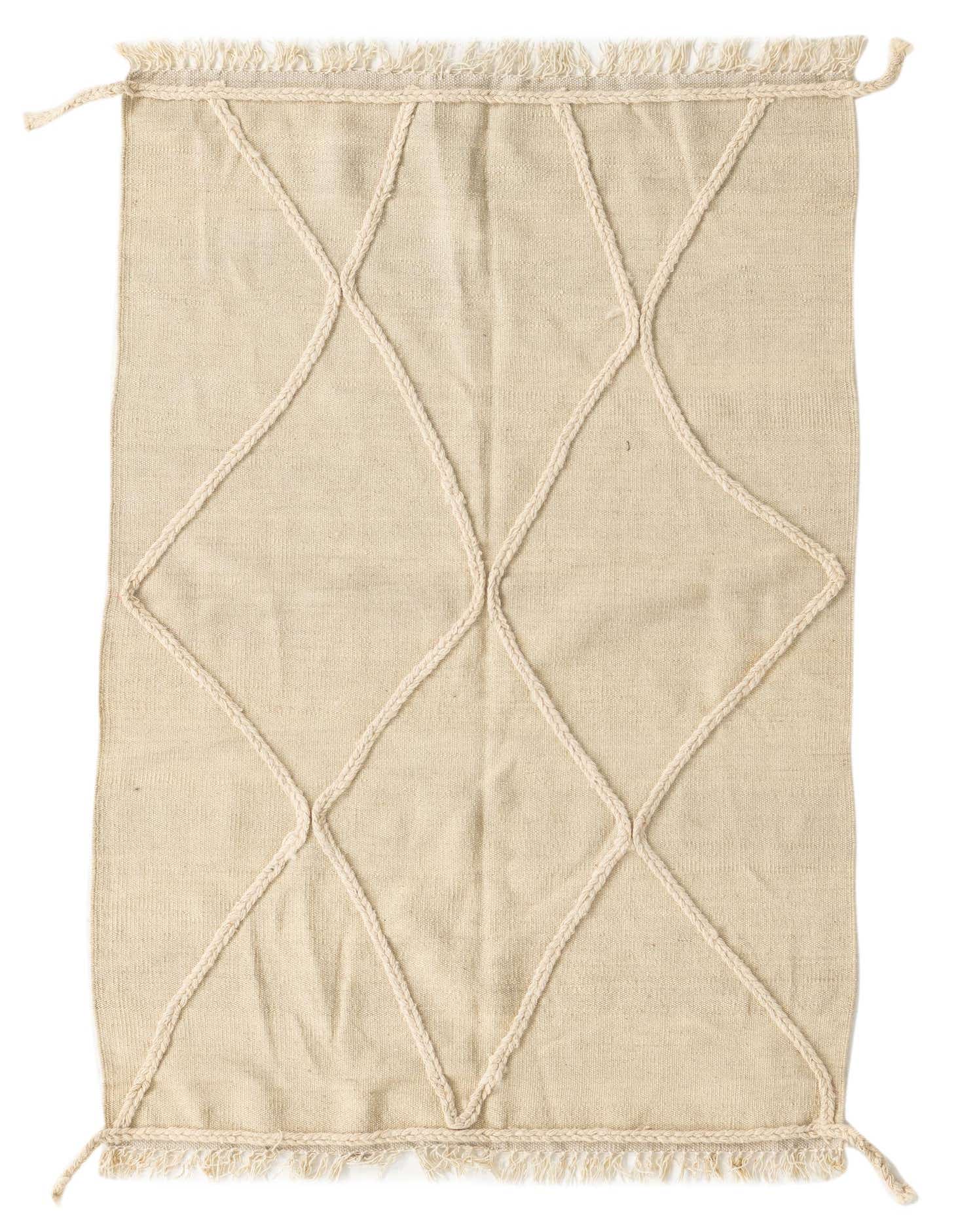 A 3x5 rectangular ivory wool shag rug with a raised tribal diamond pattern and fringed edges.