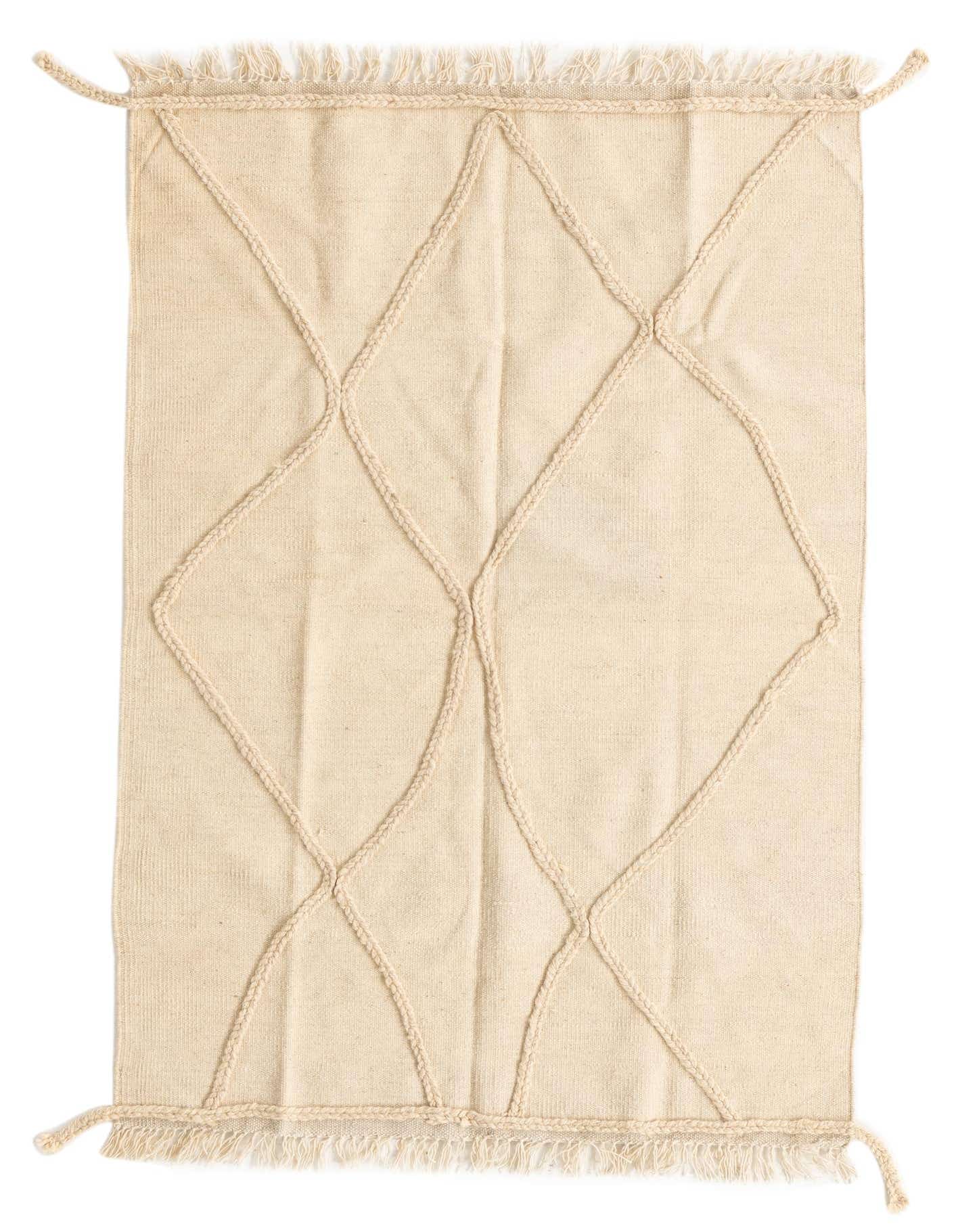 A 3x5 rectangular ivory wool shag rug featuring a raised tribal diamond pattern and fringed edges.