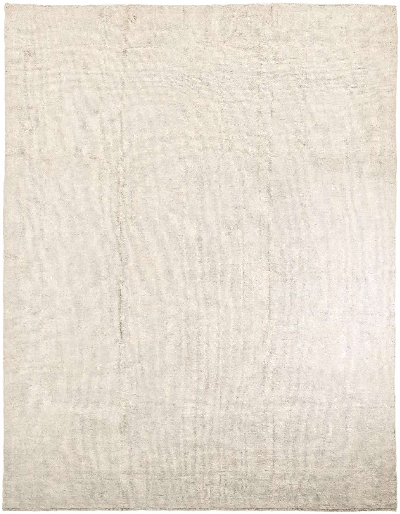 A large 10x14 rectangular ivory shag rug with a subtle tribal pattern, perfect for a living room.