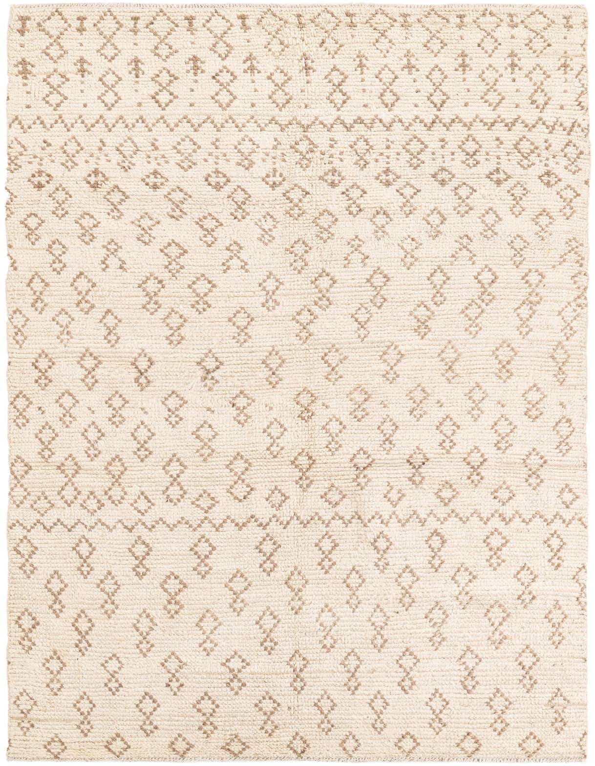 A 5x8 rectangular ivory wool shag rug with a subtle tribal diamond pattern in light brown, perfect for a modern living room.
