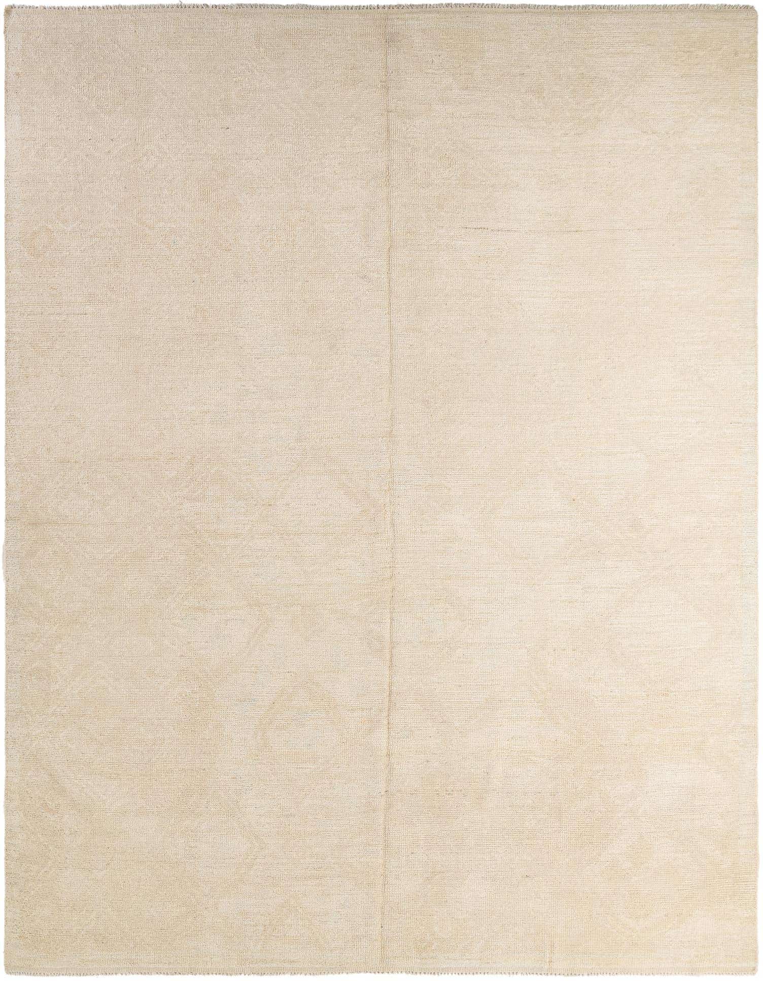 A 9x12 rectangular ivory shag rug with subtle tribal patterns, suitable for a living room or bedroom.