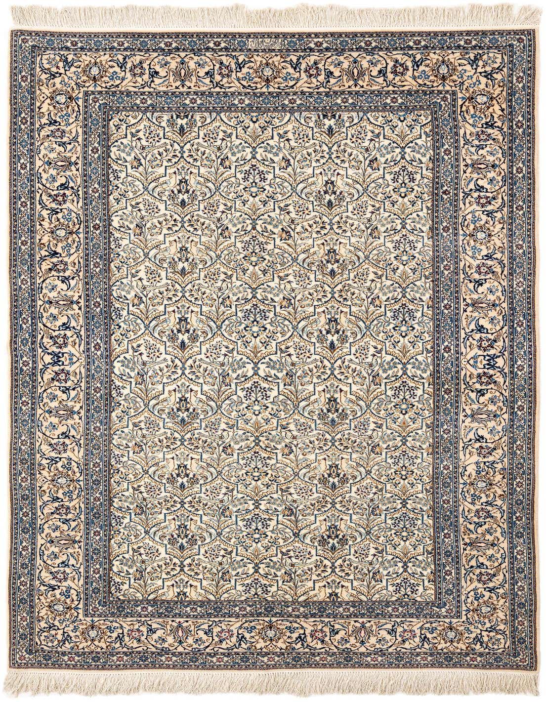A handmade rectangular Persian rug in ivory and cream with intricate blue floral patterns and a detailed border.