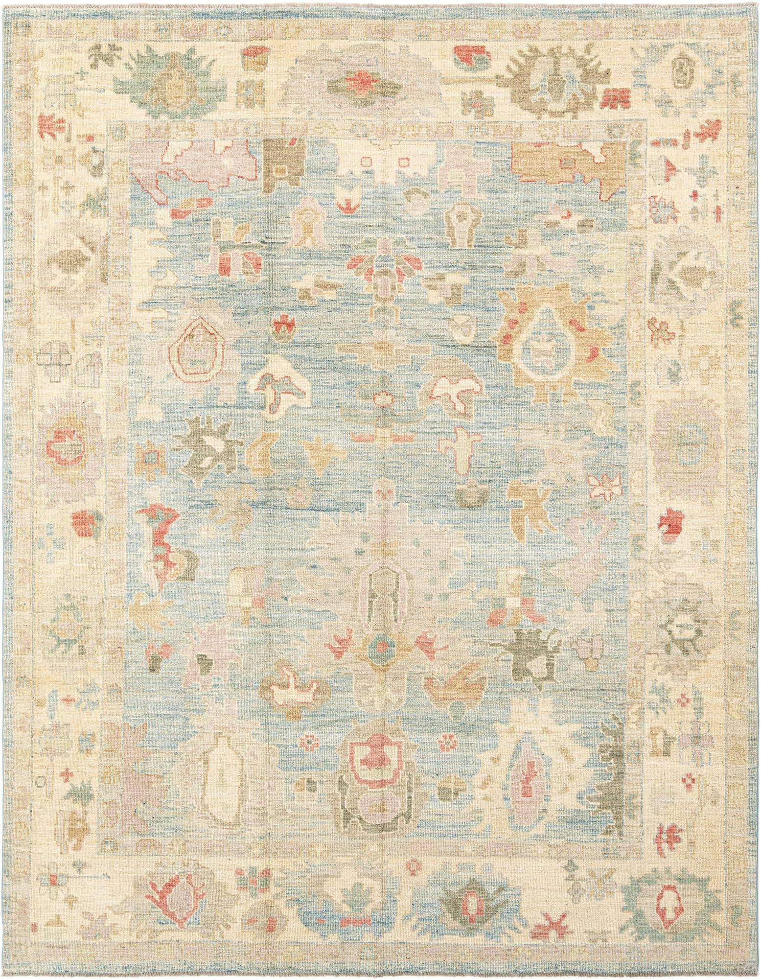 Handmade rectangular Oushak rug with a light blue center field and an ivory border, featuring faded Persian floral motifs in muted tones.