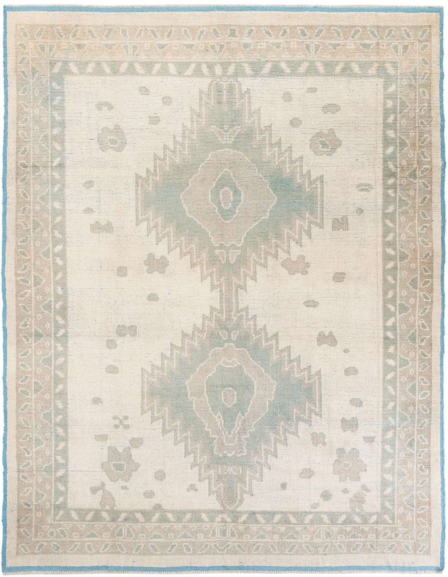A 9x12 rectangular ivory wool rug with a modern medallion pattern in muted teal and beige, featuring a light blue border.