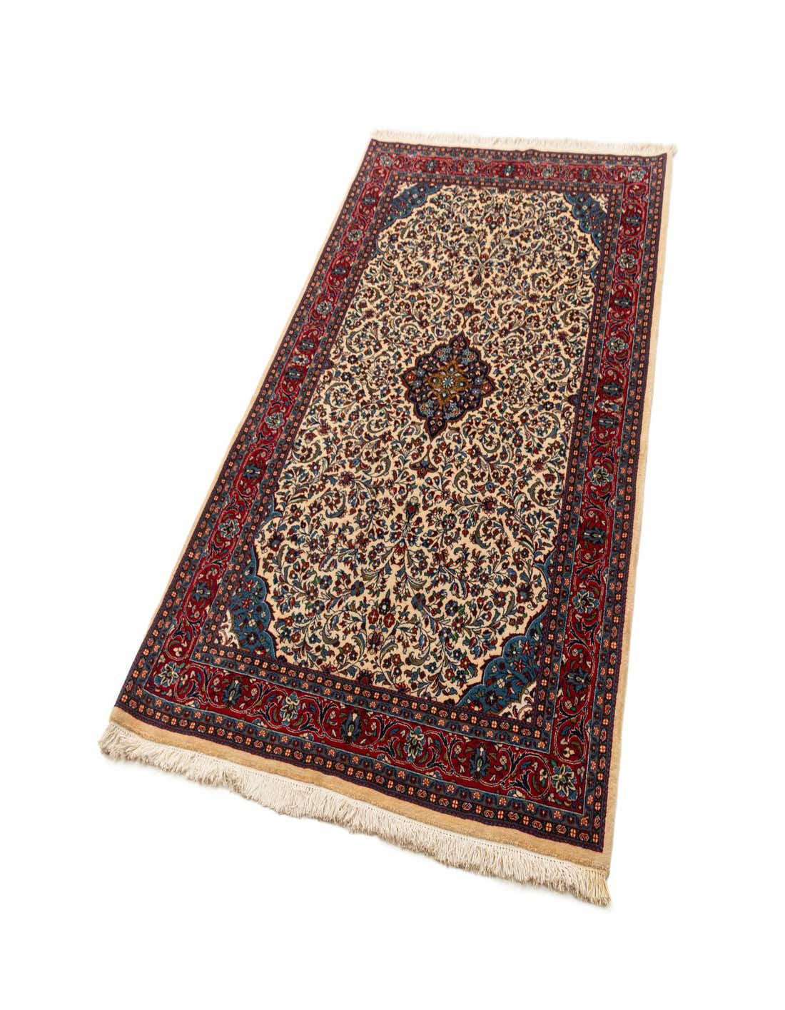 A 4x6 rectangular ivory Sarouk rug with a detailed floral and medallion pattern in red and blue, featuring fringed ends.
