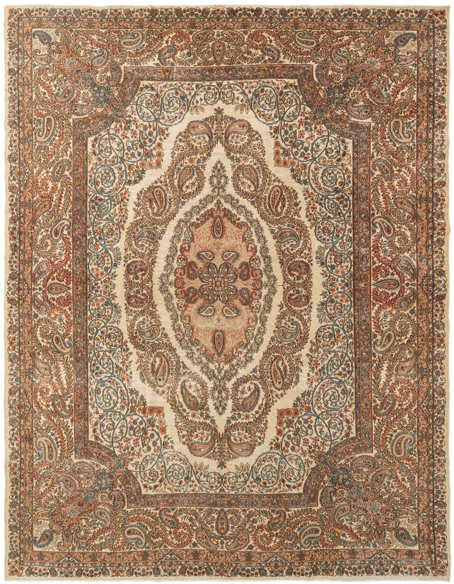 A large 10x13 rectangular ivory wool rug with an intricate traditional paisley pattern in reds, blues, and creams.