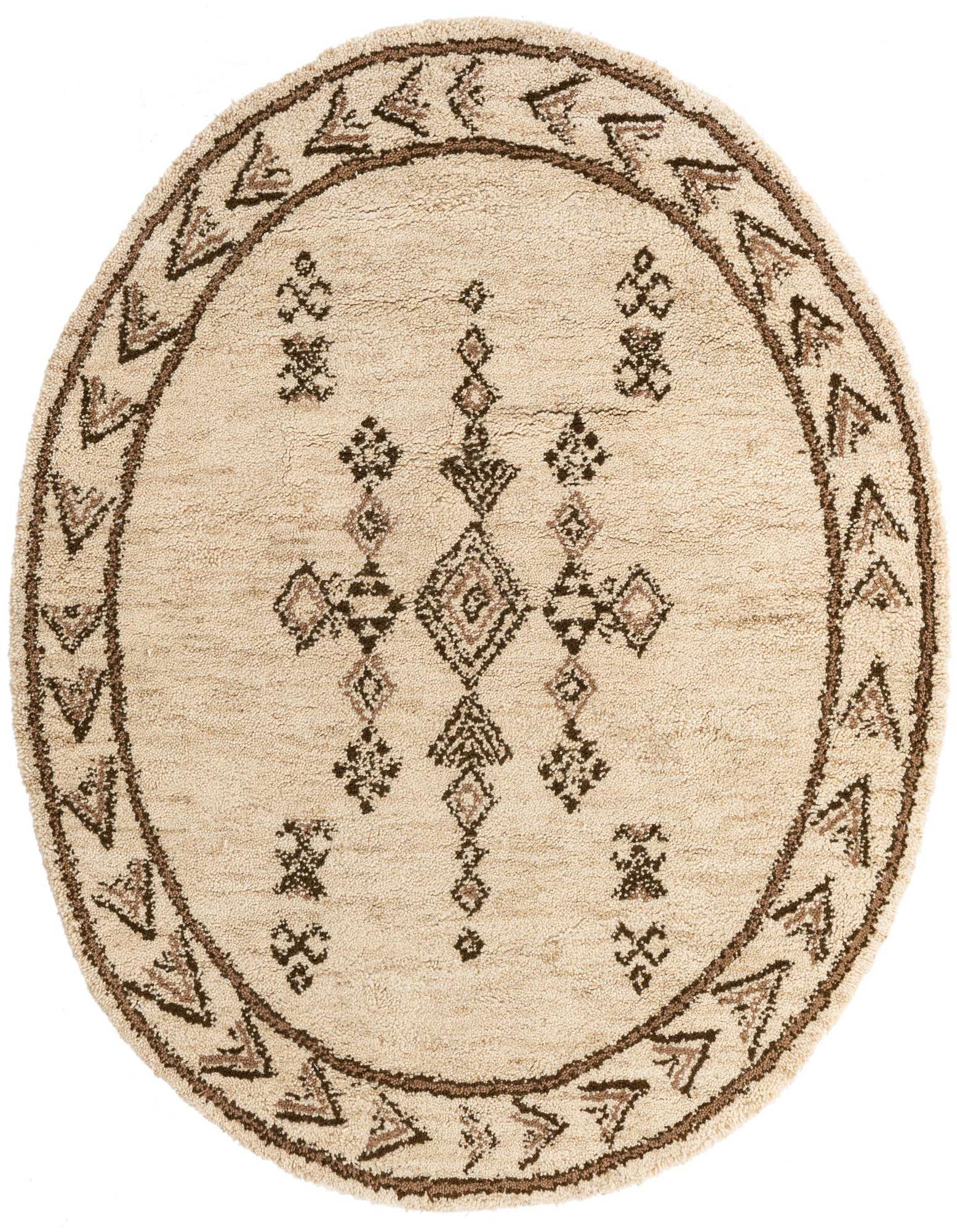 A round ivory shag rug with a central tribal diamond pattern and a border of brown geometric shapes.