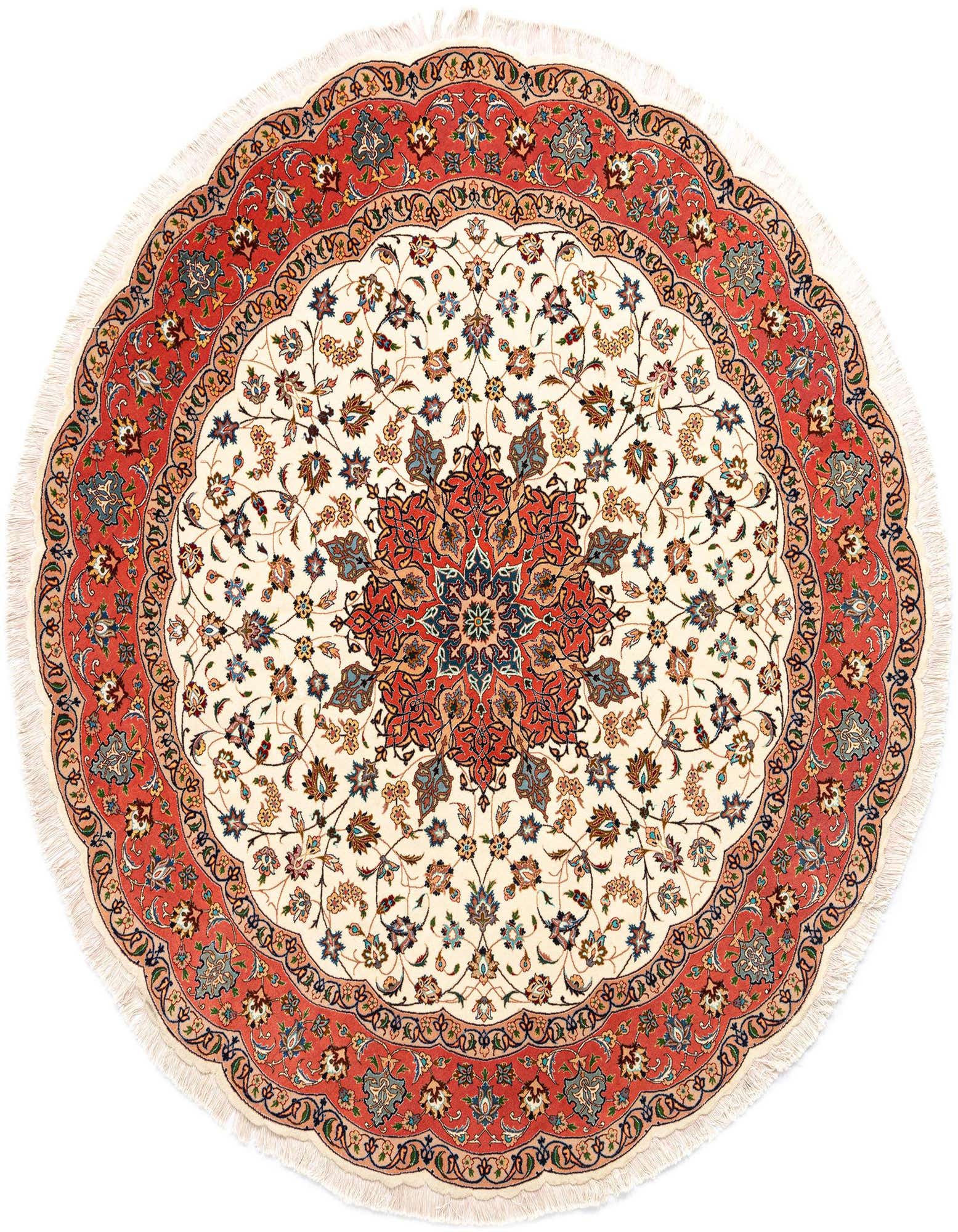 A 6' 7 round ivory Persian rug with an intricate floral medallion in red, blue, and gold, framed by a wide red border with complementary patterns and delicate fringe.