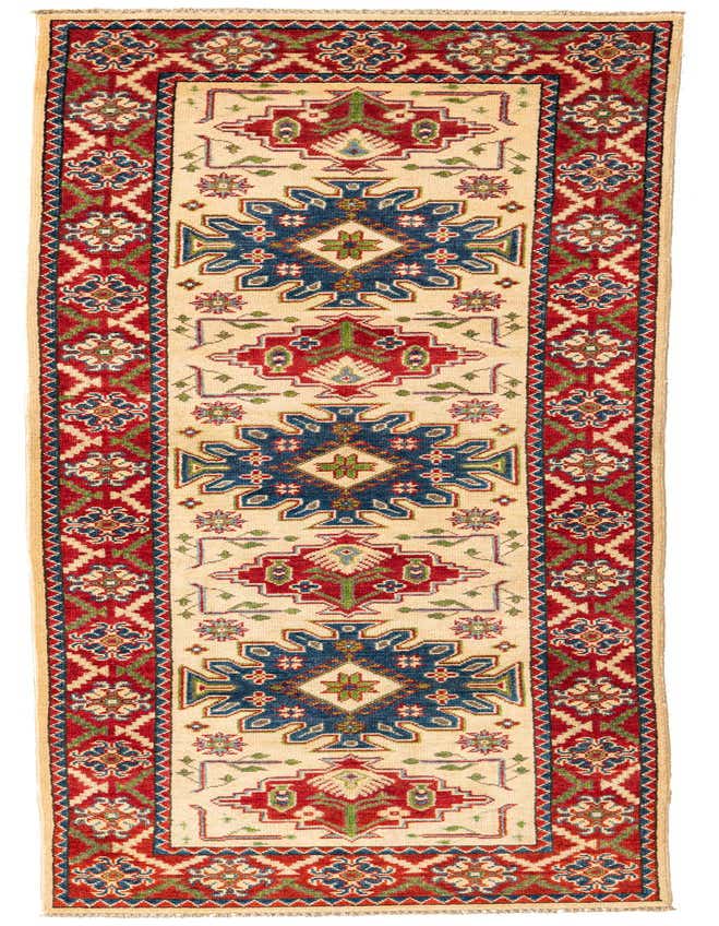 A 9 ft runner rug with a cream background, featuring bold red and blue traditional geometric patterns, ideal for a hallway.