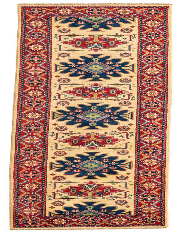 A 10 ft runner rug in traditional Southwestern style with a cream background, bold navy, red, and green geometric patterns.