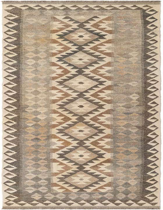 A 9 ft runner rug with a tribal geometric pattern in ivory, cream, brown, and gray, perfect for a hallway.