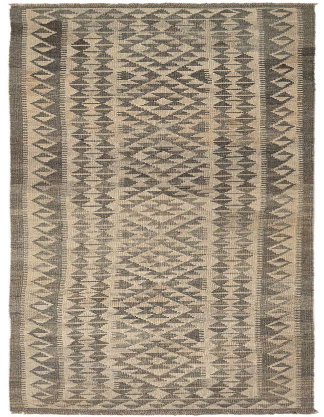 A 10 ft runner rug, the Kilim Maymana features a flatweave tribal pattern in ivories and creams, perfect for a hallway.