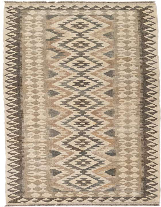 A 10 Ft Kilim Maymana runner rug in ivories/creams with a tribal geometric pattern, perfect for a hallway.