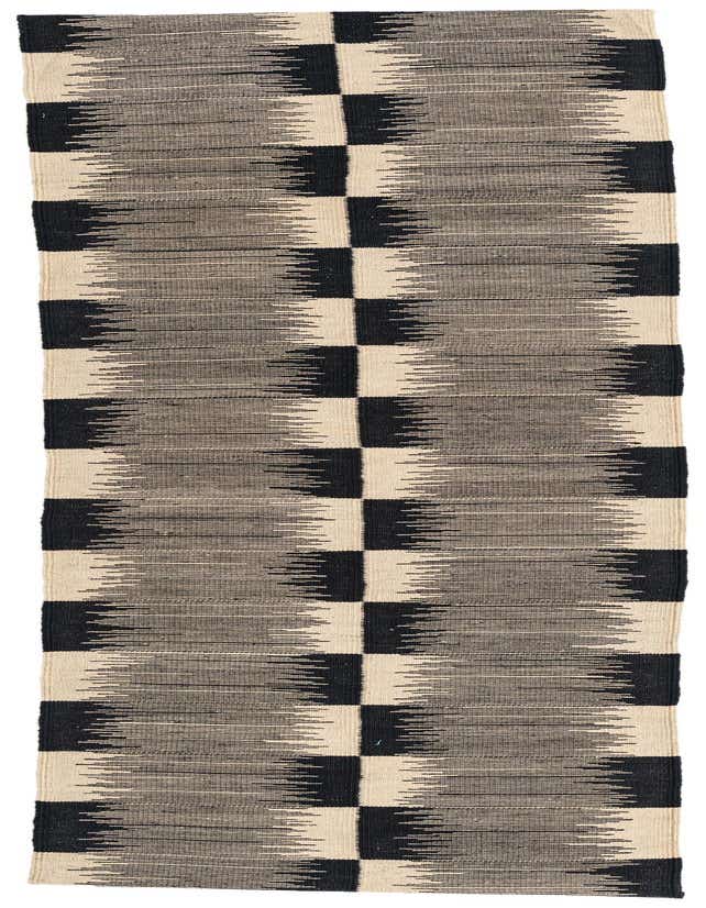 An 8 ft runner rug featuring a modern tribal pattern with ivory and black alternating blocks, suitable for a hallway or kitchen.