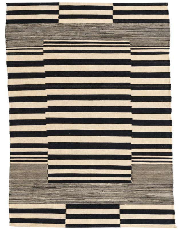 A 10 ft runner rug featuring a tribal modern design with bold black and ivory stripes and geometric blocks, perfect for a hallway.