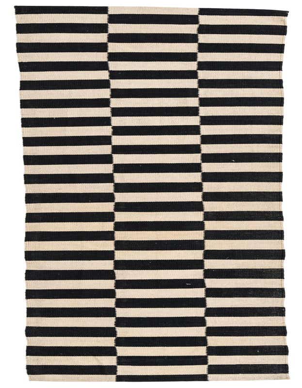 A 10 ft runner rug featuring a bold black and ivory striped pattern, perfect for a hallway.